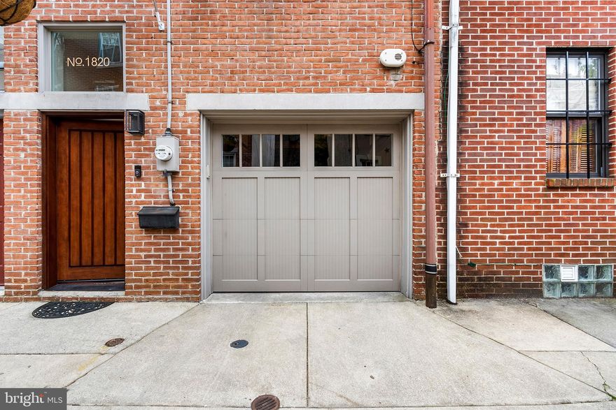 You asked and our Sellers delivered!  Lovely townhouse situated on a quiet street in the northern part of the Graduate Hospital area and it  has GARAGE parking with exterior keyless entry.  The entry level porcelain tiled foyer leads to the garage, and a combination home office with radiant heated floors (could be workout area) and laundry area, with a door leading out to an attractive garden and a great spot to have dinner with friends on a summer night.  There is a half bathroom located on this level as well.  The next level greets you with the living room with a cozy wood burning  fireplace and then steps up to the kitchen/dining area with three windows looking out onto this lovely street.  The kitchen with warm cherry shaker cabinets features extensive counter space, a Thermador 36 inch  gas cooktop ,a steam wall oven, dishwasher, a wine refrigerator,  and amazing storage.  There is under cabinet lighting and hidden outlets. The next level is where the main bedroom is situated with the quiet south facing windows, and the bathroom features a dual flush Duravit toilet, wall hung vanity, a stall shower with a rain head  shower head and handheld spray.  .  There are two additional bedrooms and an additional bathroom as well.  Steps access a roof with fantastic city skyline view .