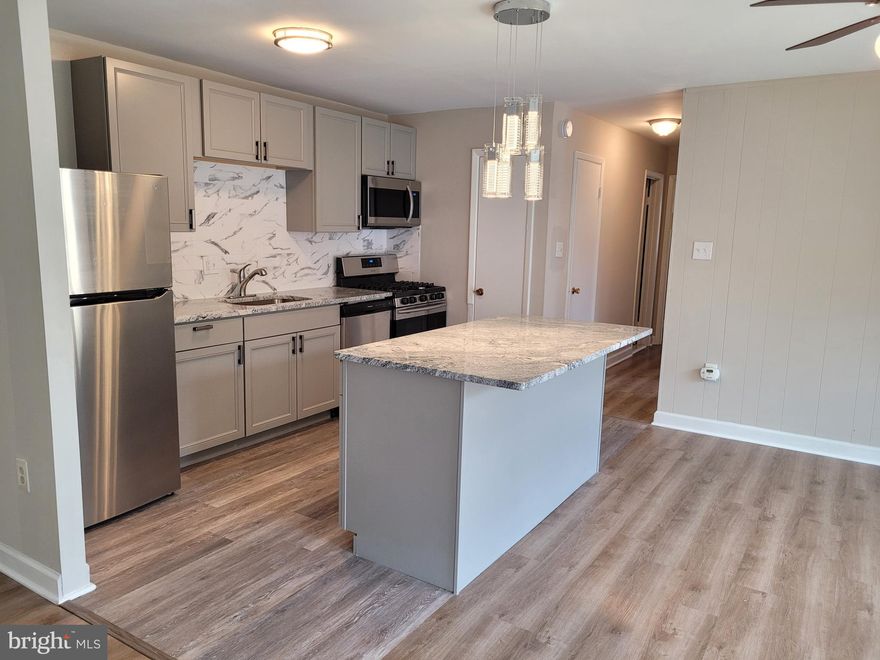 Rare unit to find backing up to the woods for spectacular views of nature and privacy.  All utilities INCLUDED.  Tons of parking!
Enjoy the open floor plan, luxury flooring and modern finishes!  This spacious living room leads into a large eating area overlooking the patio through the extra large glass sliding door.  With ample natural light the gray and white granite counter tops of the island and backsplash really POP.  Enjoy the convenience of cooking with a gas stove and over head microwave to save counter space.  The kitchen is freshly remodeled just for you.    Your large closets are made even more efficient with a storage and hanging system installed in every closet.  Keep going to find the beautifully updated bathroom.  The hallway ends at bedroom 1, the largest.  This bedroom is located at the end of the complex.  You will enjoy waking up to uninterrupted views of nature. First floor entry with only 6 steps up. Community Pool, playgrounds, tennis courts, and grilling areas.  Plenty of parking for everyone!