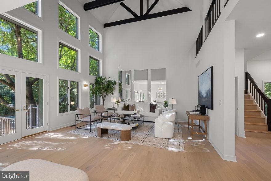 Set on 1.4 acres of serene, wooded landscape in the exclusive Velvet Valley community, this newly renovated contemporary 5-bedroom, 6 bathroom  residence redefines modern luxury.   A striking entryway opens to double-height ceilings and new white oak flooring, creating an immediate sense of space and light. Expansive picture windows and skylights fill the interior with natural illumination. The den or dining room features a wood-burning fireplace, spiral staircase,  and built in cabinetry with a beverage fridge, making this warm space inviting for everyday living as well as for entertaining.  The  living room serves as the heart of the home—an expansive, light-filled space that reflects the home’s contemporary elegance. Soaring ceilings and a wall of picture windows create a stunning sense of openness and offers  natural light throughout the day. Designed for versatility and comfort, the room offers ample space for multiple seating and living areas. Glass doors open directly to the outdoor deck and pool, blending indoor and outdoor living and making the most the home’s serene natural surroundings. The custom-designed kitchen features a full suite of Viking appliances—a six-burner electric cooktop, wall oven, refrigerator, and microwave—paired with quartz countertops and MasterBrand cabinetry. Recessed lighting enhances the sophisticated ambiance that flows seamlessly through every room.  The primary suite is a private sanctuary, complete with vaulted ceilings, a private balcony, and a large walk-in closet with a built-in jewelry safe. The spa-inspired ensuite bath features double vanities, a luxurious soaking tub, and a grand shower with multiple showerheads, creating an atmosphere of indulgent relaxation. On the upper level a  second ensuite bedroom, three more additional bedrooms,  and a third full  bath provide exceptional comfort for family and guests.  On the lower level, more than 1,000 square feet of finished living space with extra-tall ceilings, a half bath, and walk-out access invite endless possibilities—ideal for a lounge, home theater,  art studio, or fitness area. The adjacent unfinished area allows for further customization by new owners.  The exterior is equally impressive with a circular driveway leading to a  four-car attached garage.  A private backyard oasis features a heated pool, large deck, and patio—a perfect setting for relaxed outdoor living.   Located minutes from Owings Mills, Timonium, and Hunt Valley, with convenient access to shopping, schools, parks, 83 and 695,  this exceptional property offers the ultimate in privacy, design, and convenience. Experience luxury living in one of Baltimore County’s most coveted enclaves.