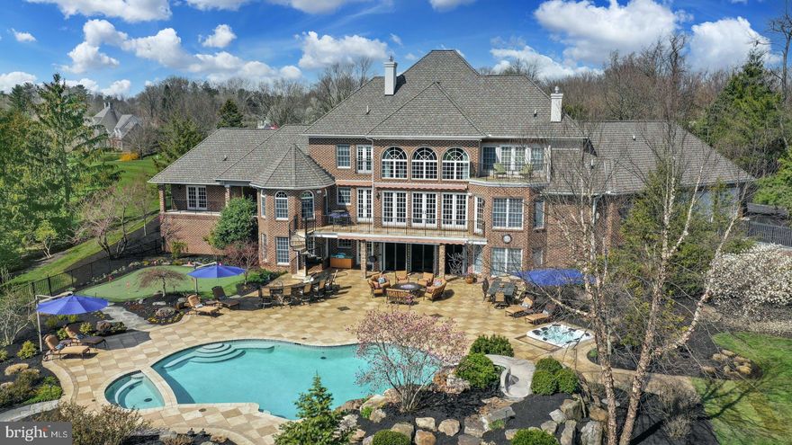 This custom built home on 1.84 acres offers an open floor plan featuring spacious rooms in more than 8,395 square feet of living space on 3 levels. At entry the living room & dining room flank the foyer that boasts a sweeping double staircase. The 2021 kitchen, outfitted with the finest appliances & finishes, flows seamlessly into the 2-story great room. A 1st floor primary suite w/ 2021 bath offers every amenity to soothe & pamper including a state-of-the-art bath. Additionally, there are 5 BRs, a separate guest suite, & lower level that boasts 2,638 feet of living space. The rec room has NanaWall doors that open to the pool, spa, & outdoor kitchen. Multiple TVs & bar are the highlights of this recent renovation. Additionally, there is a bedroom suite w/full bath, exercise room, & wine room. Expertly planned for optimal entertaining, the salt-water pool with waterfall & spa, the separate inground hot tub, putting green, & tether ball court are all luxurious areas.