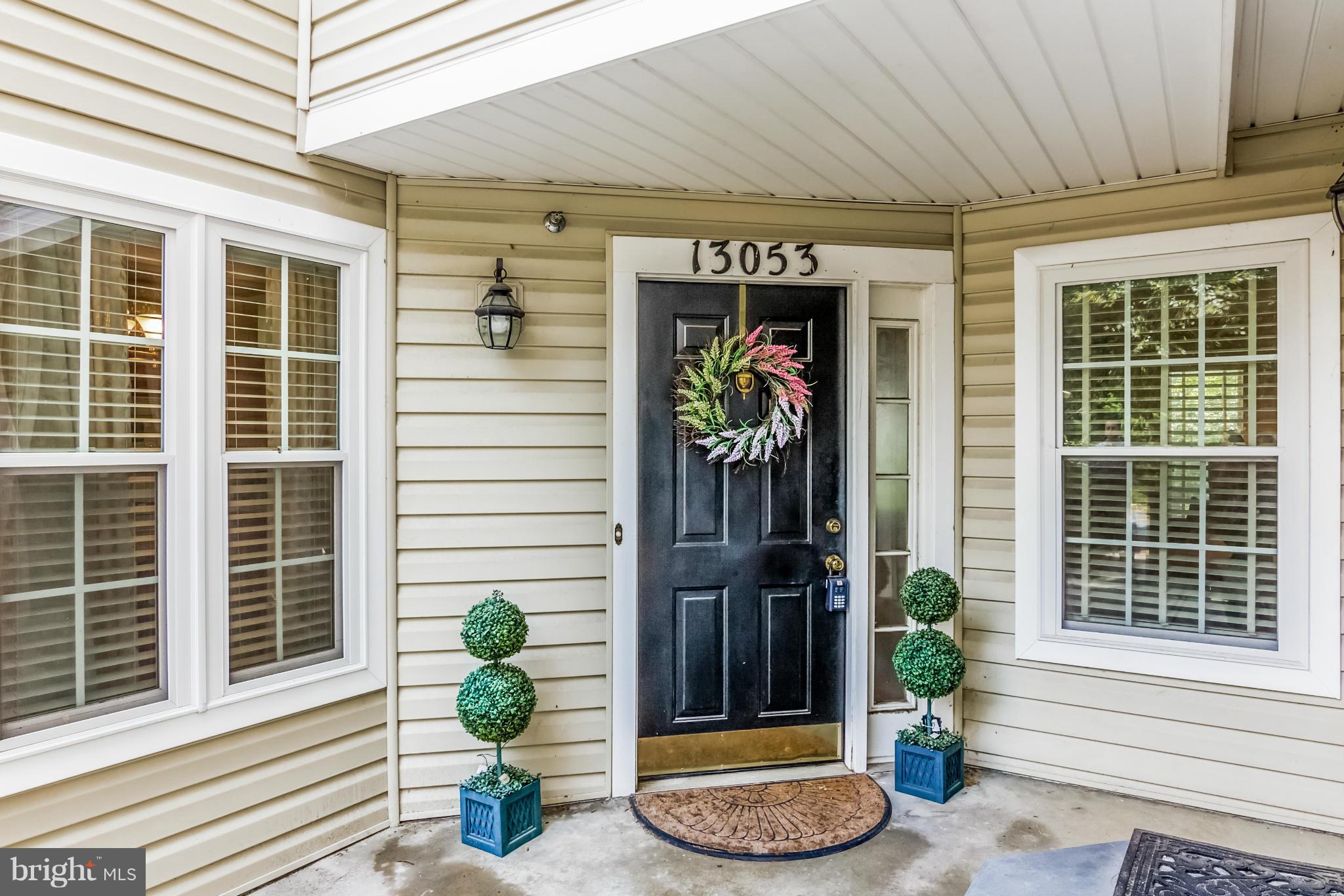 Clean, bright, spacious, & unique in a prime location! One level living w/no steps from assigned parking to front door! Gorgeous hardwood floors. Eat-in kitchen w/updated appliances & heat pump. Beautiful gas fireplace in family room. Large dining room w/crown & chair molding. Two wonderful balconies! Relaxing master suite w/two large closets, double sinks, and private balcony. Handicap accessible