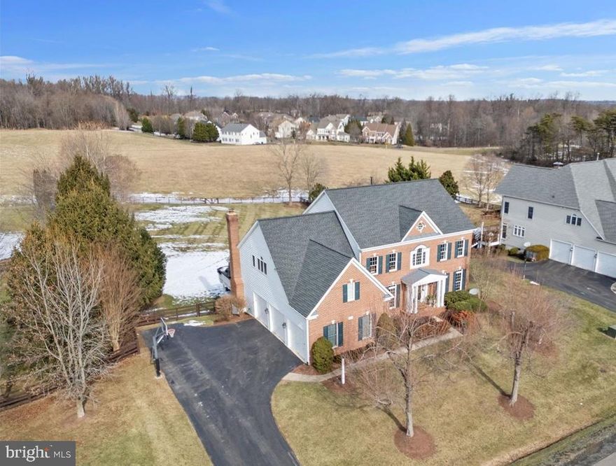 Welcome to one of the best lots in Lenah Run, a neighborhood known as a quiet, private retreat while still accessible to all the conveniences and schools of Aldie. Situated on almost an acre (.84), this home backs to a beautiful view of the designated nature conservancy. Lenah Run is one of the only Aldie neighborhoods with 50% of the 450-acre community preserved as a nature conservancy and 50% to residential lots. Marry the perfect lot offering excellent outdoor living options (including gorgeous sunsets and views) with the popular Belmont model built by Winchester Homes and it is a dream come true. Enter through the covered front portico to the 2-story foyer, gleaming with hardwood floors and a stately curved staircase. The home office with a wall of built-in bookshelves and cabinetry is highlighted by the natural light of this East facing home. On the other side of the foyer, you'll appreciate the formal living room with crown moulding and trim detail that flows to the adjacent formal dining room. Here you will take in the gorgeous views of pastures and trees. The heart of the home features a gourmet, open plan kitchen, updated with beautifully painted cabinets, newer granite countertops and backsplash. Complete with a gas Wolf gas cooktop, two Thermador wall ovens, Jenn-Air refrigerator, new dishwasher, microwave, pantry and large island with bar seating. The open floorplan includes a spacious eating area with newer sliding double door access to the screened-in porch. Enjoy all imaginable outdoor living with the stunning views, flat spacious backyard (plenty of room for pool if desired), deck, stone patio, salt water hot-tub and shed. Back inside a desk area and rear staircase complete this room. Adjacent is the 2-story family room perfect for entertaining guests and family gatherings with its high ceiling, 2-story stone fireplace and wall of natural light with newer double sliding doors highlighting the deck and the lush green backyard. A newly refinished half bath and laundry room with access to the 3-car, side load garage complete this level. The primary suite upstairs offers a spacious retreat with adjacent sitting room, 2-walk-in closets and a magnificently remodeled primary bathroom. Enjoy the stunning finishes complete with glass enclosed shower, soaking tub, separate dual vanities and water closet. Three additional bedrooms complete the upper level, two with a Jack-and-Jill full bath and one ensuite bedroom with full bathroom. The lower level is completely finished and ready for all kinds of entertaining...walk out to the rear, fenced yard and enjoy the stone patio and hot tub, relax with friends and family in the spacious rec room with wet bar and surround sound speakers, use the flex finished room for exercise, 2nd office - or as you wish! A full bath and storage room complete this level. Neighborhood amenities include community pool, many community events, tot lot, walking trails & more! Close proximity to restaurants, shopping, library, hospital & schools, <5 miles to Stone Ridge Commuter Bus & 11 miles to Silverline Metro. You will love Lenah Run!