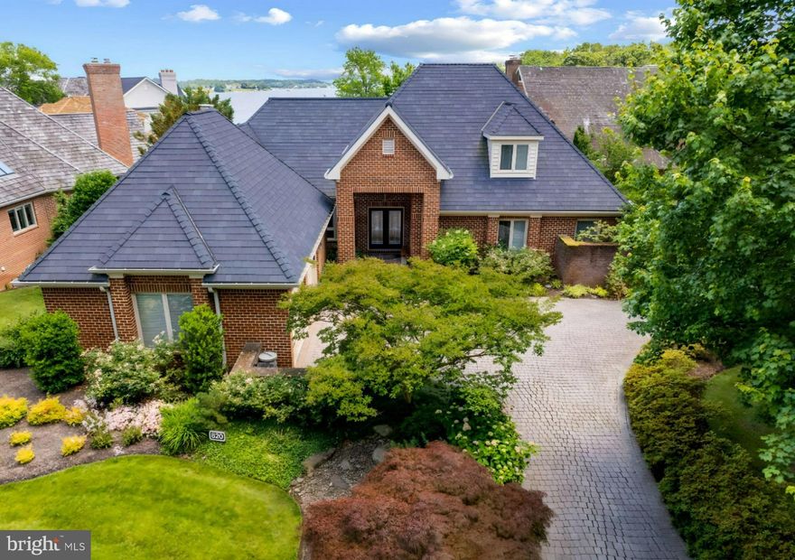 Enjoy resort-style living in this lovely brick home with peninsula views of the South River and Almshouse Creek and first right of refusal to purchase the deeded deep-water boat slip (sold separately).  This distinctive 5,300+ sq ft home showcases a lofty 2-story great room, 4 masonry fireplaces, main level primary suite with luxury bath, waterfront deck and shady covered patio.  Each upper level bedroom offers ample closet space and a private granite vanity area connected by a Jack-and-Jill bathroom with step-in shower/bathtub.  The lower level floor plan is flexible for a variety of uses and currently highlights a 2nd family room, huge den and library/4th bedroom, and access to a covered waterfront patio to the grassy lawn. Generous storage rooms and closets are found throughout.  50-yr composite roof installed in 2011 with warranty transfer to new owners.   The chairlift has been removed.  The community assn fee covers your lawn mowing, mulching, trimming and snow removal while also maintaining the 42-slip marina, swimming pool, tennis courts, playground, nature path and 24/7/365 staffed gated security.  Boat slip sold separately for $49,000.