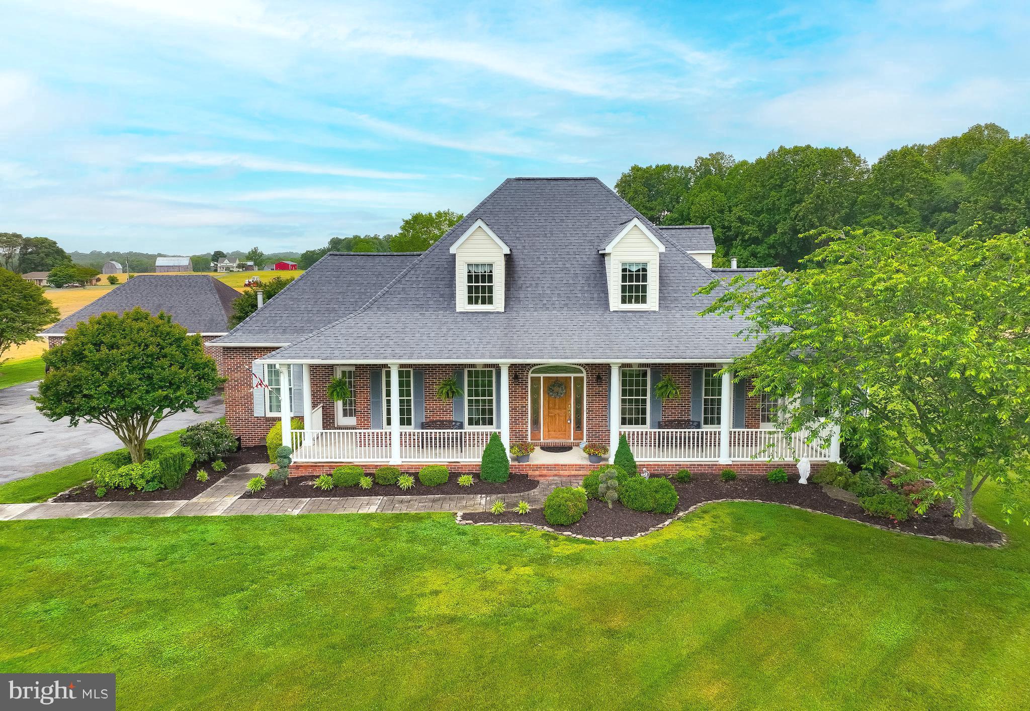 This beautiful 4-bedroom, 3.5 bathroom home sits on almost 6.5 acres of land, in the Bryantown area. Enter down your long driveway, lined with flowering trees, to a circular driveway area, with courtyard and leading to a detached, oversized 2-car garage. Your views are spectacular with surrounding farmland and nature, professional landscape and hardscape, to include stamped concrete walkways, patio and multiple porches. Once entering the home from the wrap around front porch and into the 2-story foyer, you will be enamored by pristine hardwood floors throughout the main level and the open floor concept. The large primary bedroom suite, with sitting area, is located on the main level, with 2 generously sized walk-in closets, each with custom closet systems. An additional room on the main level, can be used as an office, playroom, or sunroom, which leads to the front and back porches. There are 2 propane gas fireplaces to keep you cozy in the spacious formal living room, as well as the family room, which houses built-in shelves on either side. The heart of the home is the well-appointed kitchen with granite countertops, stainless steel appliances, custom cabinetry, new luxury vinyl tile, a walk-in pantry, a breakfast nook with plenty of windows for natural lighting and open to the family room area. A large formal dining room is where all your holiday dinners will take place, just off the kitchen and open to the 2-story foyer, as well. The grand hardwood staircase leads you upstairs to 3 good size bedrooms, all with their own full bathrooms. There are several storage closets throughout the home and a separate laundry room with utility sink and cabinets. The actual finished square footage is 3,106 of interior space; tax record is inaccurate. A storage shed is located outside behind the detached garage. The HVAC system is only 7 years young, the roof has lifetime shingles, and the septic system was just pumped in April. A home warranty is already in place, to transfer to the buyers upon settlement. Sellers may need a possible rent back. Schedule your showings now to see this exquisite property.