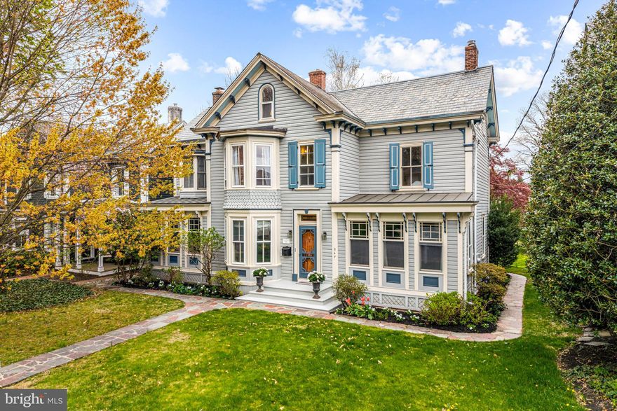 Welcome to 267 West Court Street, an extraordinary light-filled Victorian home nestled in the heart of historic Doylestown Borough. This charming three-story residence, beautifully situated on a generous double lot, seamlessly combines timeless elegance with modern sophistication, offering the ideal setting for a refined lifestyle. As you approach the home, a distinguished Bucks County slate walkway invites you to the front entrance of this spacious 3,100 square-foot home. Inside, you’ll be greeted by the warmth of hardwood floors that flow throughout most of the home along with intricate mill-work. For the culinary enthusiast, the chef’s kitchen is complete with a high-end Wolf gas range with WiFi connectivity, a Sub-Zero refrigerator, and a Miele dishwasher. A charming split Dutch door opens to the rear slate patio, offering a perfect spot for al fresco dining and effortless access to the spacious yard. The kitchen is open to both the breakfast area and the inviting family room that features a wood-burning fireplace framed by custom built-ins. A versatile home office/flex space is tucked away, offering built-in shelving and an abundance of natural light from windows on three sides. The formal dining room is a true showpiece, highlighted by an oversized bay window and is the ideal space for hosting memorable dinners. An antique glass cabinet with display shelves and a chandelier suspended from a detailed medallion add the perfect finishing touches to the room. The expansive living room, bathed in natural light, features a second wood-burning fireplace adorned with Moravian tiles, creating a cozy and welcoming atmosphere. On the second floor, you'll find four well-appointed bedrooms, including the primary suite, which offers ample closet space and a private bath with elegant wainscoting and a separate vanity area. The second bedroom is adjoined by a cozy sitting room, which could easily be converted back into a third bedroom, complete with a closet and a beautiful stained glass window that adds character and charm. A sun-drenched fourth bedroom features generous closet space. A new laundry room, brought up from the basement, has been added to the second floor for convenience with closet space. The large hall bath offers a glass-enclosed shower and a linen closet for added storage. The third floor adds even more versatility with two additional rooms and a half bath.  A full unfinished basement provides additional storage space and a Bilco door for easy access to the rear yard. Moving to the outside of this property, discover a beautiful oversized backyard with a large slate patio, offering plenty of space for outdoor enjoyment. The detached two-car garage features a floored second floor,  an electric charging station and two private parking spots, ensuring convenience for you and your guests. Lastly, this distinguished home is equipped with central air conditioning, gas heat, and a whole-house generator for peace of mind and has low taxes! Located in the quaint  Doylestown Borough, this property offers the ultimate walk-able lifestyle with easy access to charming boutiques, award-winning restaurants, lots of recreational options and the Doylestown Train Station, making it an ideal location for both work and play.