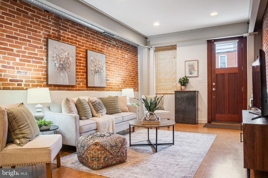 This beautifully renovated 1875 rowhome in the heart of Locust Point offers the perfect blend of historic character and modern convenience. Completely reimagined in 2014, the home was thoughtfully designed with exposed brick and custom woodwork throughout, accented by a striking steel I-beam that spans all three levels, creating a seamless balance between industrial style and timeless charm.

The main level welcomes you with an open-concept living and dining area, perfect for entertaining or everyday comfort. The gourmet kitchen is a true centerpiece, featuring stainless steel appliances, sleek cabinetry, and ample counter space for meal prep and gatherings. A conveniently located half bath completes the first floor.

Upstairs, every bedroom enjoys its own private en-suite bathroom, making this home ideal for those who value both privacy and functionality. The second-floor laundry with stackable washer and dryer adds everyday ease, while multiple closets and clever storage solutions keep the home as practical as it is stylish.

Outdoor living is just as impressive. The rooftop deck offers sweeping city views, making it the perfect spot for morning coffee or evening relaxation. Out back, you’ll find a private patio and cedar shed, providing additional storage and space for gardening, grilling, or hosting friends.

This home’s location is hard to beat. Just steps from Latrobe Park, residents can enjoy playgrounds, sports courts, turf fields, a dog park, and the neighborhood rec center. Fort McHenry, local dining favorites, and grocery stores are all nearby, and easy access to I-95 puts the entire city and surrounding areas within reach.

Whether you’re looking for a stylish city residence or a turn-key home in one of Baltimore’s most vibrant neighborhoods, 1457 Hull Street delivers charm, comfort, and convenience in equal measure.