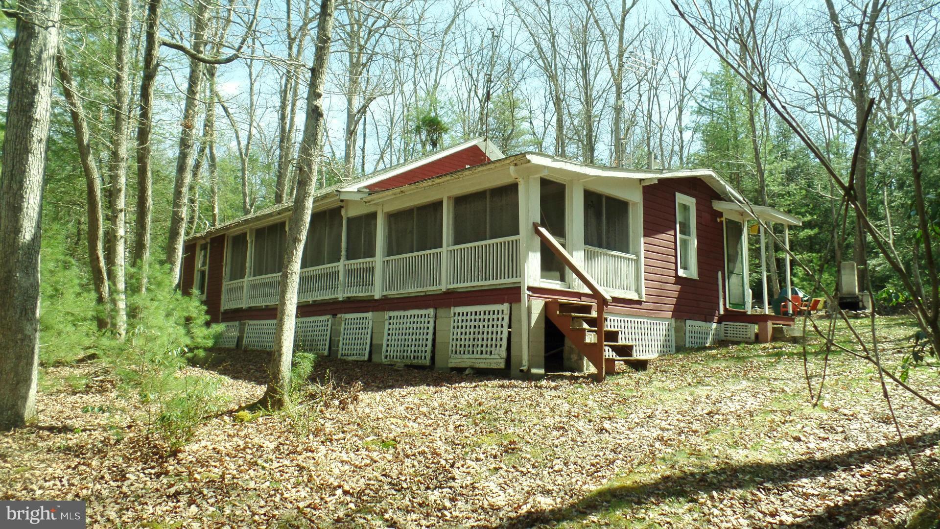 Absolutely adorable cabin in the pines! Located between Caledonia State Park and Pine Grove Furnace, this cabin offers a large equipped kitchen, comfortable, furnished living room, two bedrooms on the first floor and one large furnished room upstairs for the grandkids to use! On leased ground, the same family has enjoyed summers here for over fifty years!
