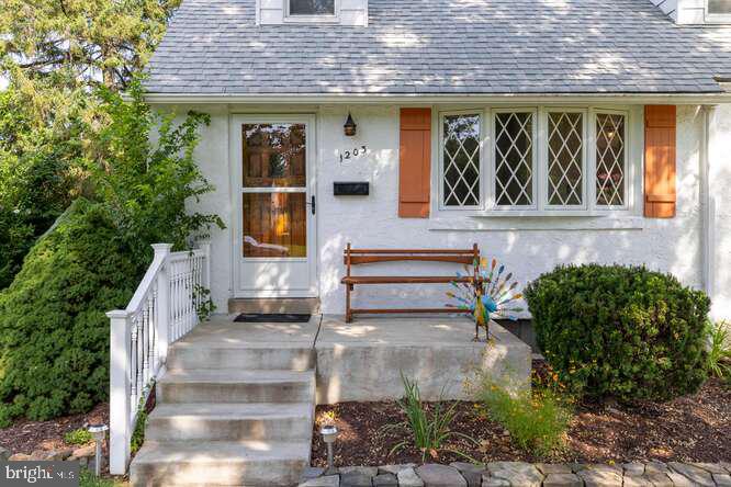 Looking for a solid home that maintains its vintage charm while offering thoughtful updates and modern amenities? Check out this adorable, surprisingly spacious Cape Cod, which has had just two owners since it was built in 1951. Set on a quiet street, the front door opens to a generously sized living room. The front bay window lets in plenty of morning sun in the winter, while the maple tree in the front yard blocks much of that sun during the hottest parts of the year. Original hardwood floors throughout the home have been uncovered in recent years and are in beautiful shape. The eat-in kitchen is mostly vintage, and all appliances are in top-notch working order. A garbage disposal was installed a few years ago, and new vinyl flooring and overhead lighting were added in 2024. Adding to the retro vibe is the recently updated bathroom, where new wallpaper, vanity, cabinet, mirror, and light fixture perfectly set off the original pink and black wall and floor tiles. Two good-sized bedrooms, a linen closet, and a coat closet complete the first floor. Upstairs are two more large bedrooms, several closets, and tons of additional storage space. The knotty pine paneling, also in excellent shape, creates a cozy rustic atmosphere. The finished basement provides yet more living space, along with sizeable tool and laundry areas. The basement also includes a sump pump, a large Utilatub, and plenty of shelving. A new furnace was installed in 2021, at which time central air conditioning was added to the home. The roof, also replaced in 2021, features light-colored, energy-efficient shingles. 2023 brought a new washer and dryer and a new back door from Guida. The backyard is large, level, and private, with plenty of space for kids and/or entertaining. If fresh fruits and veggies are your thing, you’ll love the enclosed garden area and two blueberry bushes! And a spacious shed offers plenty of room for all your outdoor tools and supplies. Finally, this beautiful home is within walking distance of the Morton SEPTA station (zone 2) and downtown Swarthmore, as well as just a few minutes’ drive from both 476 and 95. It’s the best of all worlds; schedule a tour. Showings Begin Wednesday 7/30.