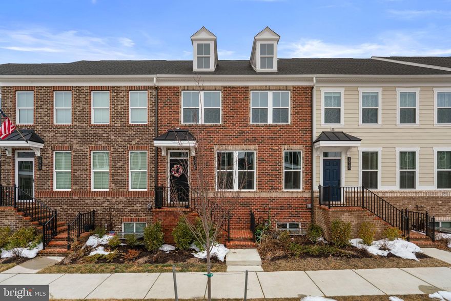 Stunning and spacious, this beautifully appointed townhouse residence offers 5 bedrooms, 4.5 bathrooms, 2,850 finished square feet, and a 2-car garage in tranquil Middle River. Step inside the open-concept main level, where a welcoming foyer with a convenient coat closet sets the tone for the home’s thoughtful design. The space unfolds effortlessly into a generous living room filled with abundant natural light, creating a bright and inviting atmosphere ideal for both everyday living and entertaining. Seamlessly connected to the living room is the impressive eat-in kitchen. It features an oversized island with bar seating and pendant lighting, a striking backsplash, stainless steel appliances, rich wood cabinetry, and ample counter space for meal preparation. The adjoining breakfast area provides access to a conveniently located main-level powder room. Both the kitchen and dining area offer sliding door access to a large covered balcony, perfect for outdoor dining or hosting guests. Upstairs, you’ll find three comfortably carpeted bedrooms and two full bathrooms, including the serene primary retreat. This private haven boasts an en-suite bath complete with a dual-sink vanity, a soaking tub, and a separate shower with a built-in bench seat. A centrally located laundry room and an additional full bathroom enhance everyday functionality. The uppermost level offers a versatile loft space ideal for a lounge, media room, or home office, with direct access to a rooftop deck. This level also includes a fourth bedroom and another full bathroom, providing flexibility for guests or multigenerational living. The lower level expands the home’s versatility with a fifth bedroom, a full bathroom, and convenient interior access to the 2-car garage. With a large covered balcony on the main level and a rooftop deck above, this residence seamlessly blends expansive indoor living with desirable outdoor spaces.
