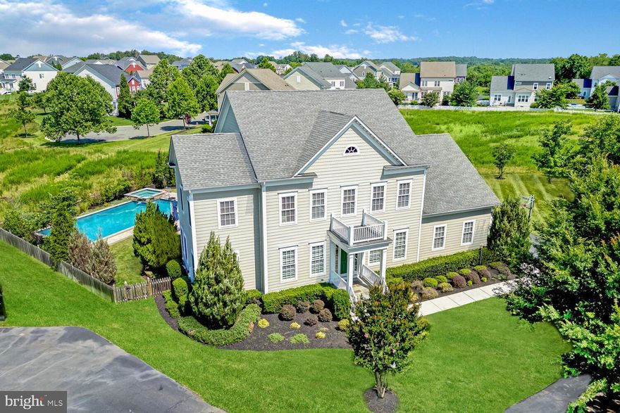 Discover elevated living in The Grange at Willowsford. This stunning Everhardt model by K. Hovnanian is nestled on a beautifully landscaped .42-acre cul-de-sac lot in one of the community’s most sought-after sections. With its striking curb appeal, fenced backyard, and private outdoor oasis complete with a resort-style pool, this home is designed to impress at every turn. Boasting 4 spacious bedrooms, 4 full bathrooms, and 2 half bathrooms across three impeccably finished levels, it offers the perfect harmony of luxury, comfort, and everyday functionality for the modern lifestyle.
<br><br>
The main level welcomes you with a foyer featuring detailed millwork and wide plank hardwood flooring that flows throughout. Formal living and dining rooms provide sophisticated spaces for entertaining, while the gourmet kitchen boasts granite countertops, shaker-style cabinetry, a stylish backsplash, and a spacious island with seating. The adjacent breakfast room opens to a climate-controlled enclosed porch—an inviting year-round retreat. A built-in workstation adds function to the layout, while the family room, complete with a gas fireplace and porch access, creates a cozy space for gatherings. A private home office/den and a beautifully designed mudroom with built-ins, shiplap accents, and ample storage complete the main level.
<br><br>
Upstairs, the elegant primary suite offers a serene retreat, featuring a tray ceiling, plush wall-to-wall carpeting, and dual walk-in closets for abundant storage. The spa-inspired ensuite bathroom is thoughtfully designed with a sleek frameless glass shower, separate vanities, and upscale finishes that elevate everyday living. Three additional bedrooms provide comfort and flexibility—one with its own private ensuite and walk-in closet, while the other two share a beautifully appointed hall bathroom. A conveniently located laundry room on the upper level adds everyday ease to this thoughtfully designed home.
<br><br>
The fully finished walk-up basement is a true extension of the home’s living space, designed for relaxation and recreation. Enjoy movie nights in the expansive rec room, complete with a custom built-in entertainment center and wet bar with storage. A separate media/game room and dedicated home gym accommodate a variety of lifestyles. Guests will feel at home in the private den, featuring a walk-in closet and attached full bath with a luxurious frameless glass shower and high-end fixtures. A half bath and a cozy reading nook tucked away for quiet moments add even more function and charm.
<br><br>
Step outside into your private backyard paradise. The enclosed porch is a showstopper with a beadboard ceiling, Trex decking, fireplace, built-in ice maker and dishwasher, and full climate control for year-round use. Expansive al fresco doors create a seamless indoor-outdoor flow for entertaining or relaxing. Beyond the porch, the professionally landscaped backyard showcases a spectacular inground pool with an integrated spa, built-in seating, sundeck, and a coveted baja shelf—perfect for lounging in the water while staying cool in effortless style.
<br><br>
Willowsford stands as Northern Virginia’s premier residential community, offering a distinctive lifestyle rooted in nature, sustainability, and connection to the land. Encompassing 4,000 acres of preserved countryside, this masterfully planned enclave includes four unique villages surrounded by open meadows, forests, and working farmland maintained by the Willowsford Conservancy. Residents enjoy an exceptional array of amenities, including Sycamore House and The Lodge at Willow Lake—elegant gathering spaces with resort-style pools, fitness centers, and farm-to-table culinary experiences. A robust trail network, scenic fishing lake, amphitheater, dog park, and nature-inspired recreational areas further enrich the vibrant, purposeful lifestyle that defines this extraordinary community.