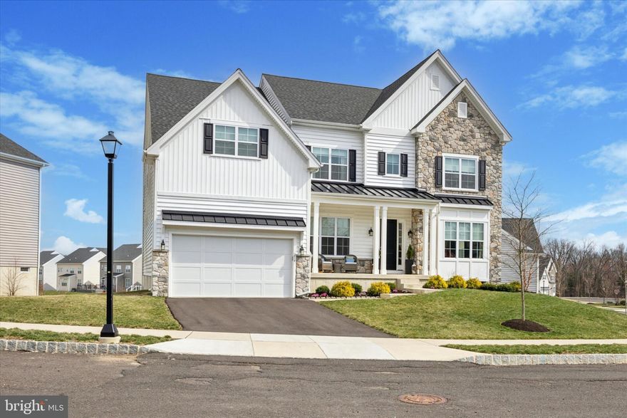 Experience the epitome of refined living in this exquisite, like-new Grayson Model estate, crafted just three years ago by JP Orleans and set on one of the most coveted lots in the prestigious Grove Valley community. Nestled within the highly sought-after Central Bucks School District, this 5-bedroom, 4.5-bath masterpiece combines sophisticated design, grand open spaces, and premier upgrades—perfect for the discerning luxury homebuyer.From the moment you arrive, you’ll know this is the one. The expanded covered front porch is both welcoming and charming, surrounded by beautifully maintained landscaping. The exterior showcases a stunning blend of stone, board & batten, and vinyl siding, giving the home its signature modern farmhouse appeal.Step inside to discover a residence that feels brand new—meticulously maintained and in pristine condition. A dramatic grand foyer welcomes you, leading to an elegantly appointed flex room—ideal as a formal sitting area or private study—opposite a stately dining room designed for unforgettable entertaining.The heart of the home is the breathtaking two-story great room, where custom built-ins frame a striking gas fireplace crowned with an architectural overmantel and detailed crown molding. The chef’s kitchen is a true showpiece, featuring ceiling-height stacked Century Avalon white maple cabinetry with glass display panels, under-cabinet lighting, gold hardware, and luxurious silestone countertops with elegant veining. The expanded 10-foot center island offers abundant seating, while top-tier appliances—including a 36” gas cooktop, double wall oven, and drawer microwave—ensure every culinary need is met. A walk-in pantry off the mudroom keeps essentials close without detracting from the kitchen’s clean aesthetic. The sunlit breakfast nook, with its vaulted ceiling, opens to a spacious Trex deck with serene backyard views.Throughout the main level, 10-foot ceilings, rich hardwood floors, and bespoke finishes create an atmosphere of casual sophistication. A private home office provides a quiet retreat, while a custom mudroom with built-ins adds functionality and style.Ascend the wide oak staircase to a second level designed for pure indulgence. The primary suite is a private sanctuary with three massive walk-in closets, a tray ceiling, and a spa-inspired en suite featuring marble-style tiles, a freestanding soaking tub, oversized walk-in shower with seamless glass, and dual vanities with gold fixtures. Three additional bedrooms offer generous proportions, including an en suite guest retreat and a stylish Jack-and-Jill bath. A second-floor laundry room adds everyday convenience.

The fully finished walkout lower level is an entertainer’s paradise, complete with a fifth bedroom, full bathroom, and expansive open space—ideal for a home theater, fitness area, or additional gathering space.Additional highlights include a 2-car garage with an upgraded electric vehicle charging outlet, hardwood floors on both the main and upper levels, custom window treatments, a whole-house humidifier, abundant recessed lighting, and proximity to top-tier dining, boutique shopping, and scenic parks.This exceptional residence—only three years old and maintained in pristine, like-new condition—is a rare blend of modern luxury, timeless elegance, and an unbeatable location. Don’t miss your chance to own this extraordinary home—schedule your private tour today.Special Financing Incentives available on this property from SIRVA Mortgage.