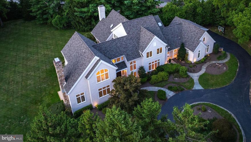 Welcome to 142 Abrahams Lane, a spectacular residence set on a serene 1.57-acre lot in one of Radnor Townships most exclusive cul-de-sacs. This exquisitely renovated home seamlessly combines the modern elegance of new construction with the rare luxuries of space and privacy. Enter the home into the grand foyer with Italian marble flooring, setting the tone of modern elegance, with sightlines up to the second floor landing. The expansive living room has a wood-burning fireplace with a marble mantle, and refinished hardwood floors that continue throughout the main level. A powder room and sitting area, leads you to the private office with built-in bookcases and access to the deck. Across the foyer is the large dining room featuring two chandeliers, custom wall mirror, and an adjacent wet bar with beverage cooler and beautiful black marble countertops and backsplash. Your eyes will immediately take you into the showstopping kitchen featuring herringbone wood floors, custom Goebel cabinetry, quartz countertops, an expansive island, a full suite of Thermador appliances, and walk-in pantry. An open breakfast room brightened by floor-to-ceiling solarium-style windows, is the ideal place for morning fare, leading out to the newly installed composite deck with views to the expansive rear yard. Stepping down from the breakfast area is the sunken family room with stone fireplace, wood beams, and remote-controlled shades. The gem of this home is the bonus room hidden behind two french doors off of the kitchen, perfect for a playroom or additional office space. Finishing off the main level is the incredibly functional mudroom with custom storage lockers and island, laundry room with heated flooring, an additional powder room, and access to the 3-car garage. Upstairs, the primary suite features beautiful hardwood flooring, vaulted ceilings, two walk-in closets, and a spa-like en-suite with Italian marble heated flooring, soaking tub, and expansive walk-in shower. Down the hall, you will find two generous sized bedrooms that share a hall bathroom with double vanity, soaking tub, and walk-in shower. Set on the back portion of the house, is an en-suite bedroom and full bath, and two additional bedrooms that share a bathroom with dual vanities, soaking tub and walk-in shower. Bedroom 7 is the perfect in-law or au pair suite and is the perfect hideaway with separate sitting area and full bathroom. The lower, walk-out, level is an entertainer’s dream. With a stylish bar, entertainment area with wood-burning fireplace, media room that opens up to the yard, and a full bathroom with heated flooring, endless memories are able to be made in this space. You will also find a large unfinished area for your storage needs and the perfect home gym. Additional updates include a new roof, multi-room Sonos sound system, full Lutron Caseta lighting packing, re-built main and secondary staircases, solid core doors with Emtek hardware, and the whole home has been freshly painted. Conveniently located near the Radnor Trail, local parks, Wayne Art Center, golf/country clubs, shops, cafes, restaurants, schools, and major highways, this home has it all.