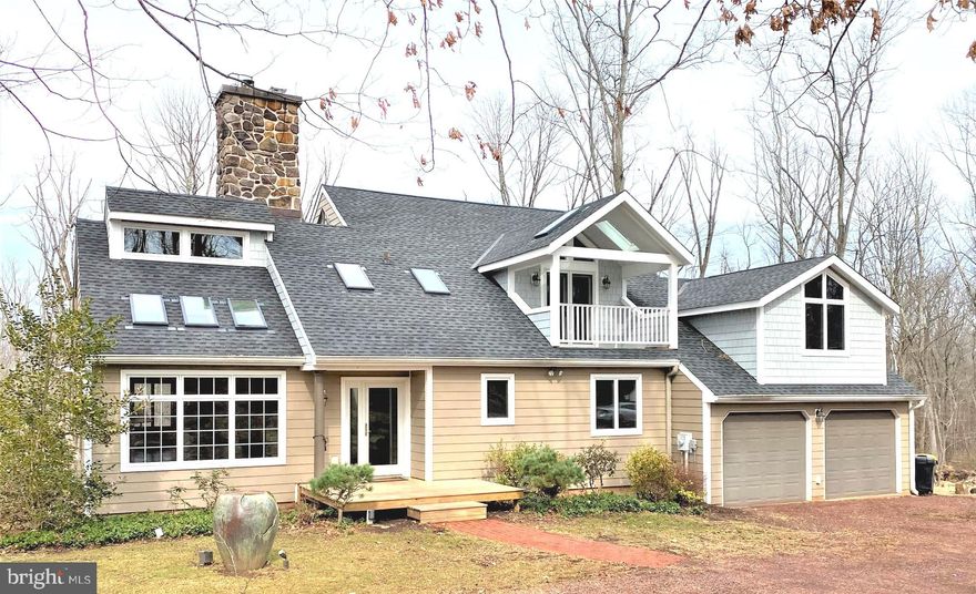 Be sure to check out the 3D Virtual House Tour! Tucked away on 10 peaceful, gorgeous acres in desirable Upper Bucks, this custom, contemporary home with an open floorplan and abundant architectural details is a nature lover’s dream and built with entertaining in mind. Walking through the doorway will take your breath away as you are greeted by cathedral ceilings, skylights, walls of windows, a floor-to-ceiling stone fireplace, hardwood floors, endless natural sunlight, and incredible views of the outdoors. The main level boasts a nicely sized bedroom with full bathroom, an enormous great room, dining room and a stunning gourmet kitchen with granite countertops, custom tile and cabinets, a six-burner gas range, stainless appliances, and direct access to two tiers of decks in the back. The primary bedroom suite takes up the entire 2nd floor and includes a cathedral ceiling, a spa-like bathroom, a private balcony, and a walkthrough closet that connects to two additional rooms (with a separate entrance!) that can be used as a home office, fitness room, reading room or private sitting room. The fully finished, walkout basement has a family room, spacious bedroom and full bathroom and can be used as a comfortable in-law suite or guest quarters. New carpet, new windows, newer sky lights and a new sand mound are great updates! Not to be missed is the 50x75’ pole barn with a 6” concrete floor, three bays with electric garage doors and a fully lit interior. The propane tank on the property was purchased outright, so you have the flexibility of choosing your own service provider and the house is wired for a future generator so that you will never be without power. In a great school district, close to Lake Nockamixon, many wonderful parks and mere minutes to the Delaware River and all that the valley has to offer. Make sure to make your showing appointment now as some lucky buyer will fall in love with this special property and it will be gone!