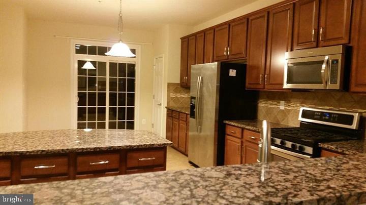 Near shopping and red line metro, 3 above ground levels large townhouse, 3 bedrooms and 2 full bathrooms and 2 half bathrooms, large eat-in kitchen with island, a lot of cabinets and granite counter top. very clean and beautiful. available immediately.