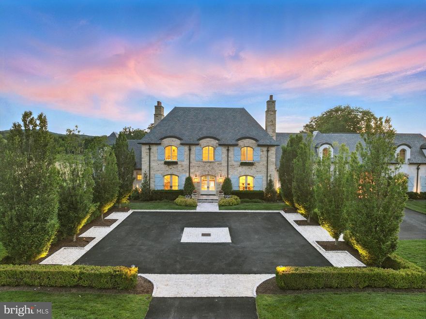 Set within the prestigious gates of Creighton Farms, 22805 Creighton Farms Drive is a meticulously crafted estate that blends timeless elegance with elevated modern living. Thoughtfully designed across three finished levels and complemented by a private carriage house, this residence offers both grand scale and refined comfort at every turn.

The main level is anchored by beautifully appointed living spaces, including a formal dining room with a gas fireplace, custom built-ins, and designer lighting. A fully equipped wet bar with Sub-Zero refrigeration enhances the home’s entertaining capabilities, while the chef’s kitchen serves as a true centerpiece—featuring stone countertops, a statement LaCanche range with pot filler, Vent-A-Hood designer hood, Sub-Zero refrigeration with integrated drawers, a Wolf coffee system, and exposed wood beams. The kitchen flows seamlessly into a sunlit breakfast nook and an inviting family room with fireplace, built-ins, and French doors. A private office wrapped in windows, a functional mudroom with stone flooring and built-ins, and a walk-in pantry add both style and practicality.

Upstairs, five spacious en-suite bedrooms provide comfort and privacy, along with a secondary wet/coffee bar. The primary suite offers a serene retreat with tray ceilings, a gas fireplace, automated window treatments, and French doors opening to a Juliet balcony. The spa-like bath features dual vanities, a Victoria + Albert soaking tub, steam shower, water closet, and a custom walk-in closet with built-in vanity. A dedicated laundry room with LG appliances completes the level.

The lower level is designed for lifestyle and leisure, featuring a wine cellar, expansive entertainment room, private theater, exercise studio, and an additional bedroom with full bath. Outdoor and indoor spaces are seamlessly connected through a covered living area with brick flooring, a wood-burning fireplace, and retractable screens—perfect for year-round enjoyment.

A detached carriage house adds exceptional flexibility, offering its own living quarters with a mudroom entry, flexible main-level living space, and two bedrooms with a full bath above. Complete with a five-car garage, dual staircases, Perrin & Rowe fixtures, and professional landscaping, this residence delivers a rare opportunity to experience luxury living at its finest.