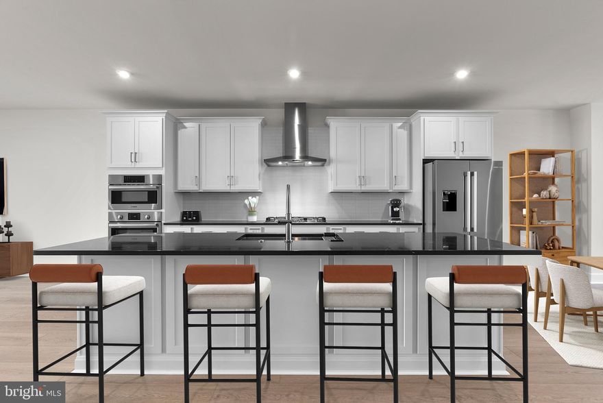 Brand new elevator style luxury Van Metre Townhouse with 3 bedrooms and 2.5 bathrooms in the Active Adults 55+ community of Lexington Square, ready for IMMEDIATE DELIVERY. The gorgeous great room with a designer kitchen includes dining space and a statement fireplace. It has access to a huge deck overlooking the open common space and backyard. The open concept gourmet kitchen features stainless steel appliances (including a 5 burner Bosh cooktop with chimney hood), a gigantic island, pantry with solid shelving, upgraded white backsplash, and incredible quartz countertops. This spacious main level also includes a study with a lovely window, perfect for every-day use, as well as an abundance of natural light throughout with beautiful, recessed lighting and 10’ ceilings that create plenty of room for life’s celebrations. The upper level has all 3 bright and spacious bedrooms. The primary bedroom steals the show with its vaulted ceilings, huge walk-in closet, recessed lighting, and a spa inspired bathroom. This primary bathroom includes dual vanities (soft close cabinets), more incredible quartz countertops, and an accessible/beautiful roll-in frameless shower (floor to ceiling tile and built-in seat). There’s more natural light throughout the 2 additional bedrooms which have stain resistant carpeting, walk-in closets, and plenty of space to relax. The second full bath is gorgeous and functional with a tub! The lower level has the main entrance and a massive recreation room that is excellent for entertainment. This is the perfect home for life’s milestones with several accessibility features, including a private elevator. There are also many sustainability features like an instant tankless water heater, structured home wiring system, and it’s ready for solar panels! Enjoy peace of mind with the builder’s post-closing warranty and move in today. This boutique community is designed with a smaller, close-knit feel to encourage meaningful relationships with neighbors. Enjoy thoughtfully curated amenities including walking trails to Lansdowne Woods, a pollinator garden close by a County preservation area, and active recreation areas. Every detail at Lexington Square has been designed to offer comfort and ease, creating the perfect backdrop for vibrant living. Perfectly situated just off Route 7, you are just moments away from One Loudoun, Belmont Chase Town Center, Lansdowne, and all the essential shopping and dining Ashburn offers. Also conveniently located close to the Metro’s Silver Line, Dulles International Airport, commuter routes, and health centers including Inova, making it a prime destination for those seeking a well-connected and vibrant lifestyle.
Take advantage of $1,000 for closing costs by choosing Intercoastal Mortgage and Walker Title.