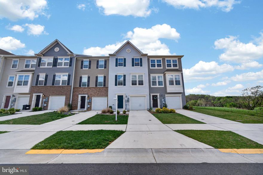 Welcome to Norborne Glebe, one of Charles Town’s most sought-after communities, where this refreshed interior townhome offers a rare opportunity backing to peaceful trees for added privacy and a serene setting. Built in 2023, this 3-level home features 3 bedrooms, 2 full baths, and 2 half baths with a well-designed layout that blends comfort, function, and modern living.

Unlike standard new construction, this home is truly move-in ready with fresh paint throughout, ceiling fans installed in key rooms, and window blinds already in place, helping buyers avoid unexpected post-closing expenses.

The entry level offers a flexible recreation space perfect for a home office, gym, or second living area with access to the backyard and wooded views.

The main level features an open-concept layout with a spacious family room that flows into the kitchen and dining area. The kitchen includes a large island, granite countertops, stainless steel appliances, and plenty of storage. Step out onto the rear deck and enjoy a private tree-lined backdrop ideal for relaxing or entertaining.

Upstairs, the primary suite features a fully upgraded walk-in closet designed to maximize storage and organization, along with a dual vanity ensuite bath and a spacious tiled shower. Two additional bedrooms, a full hall bath, and a conveniently located upper-level laundry complete the top floor.

A rare opportunity to own a 2023-built home in Norborne Glebe with privacy, thoughtful upgrades, and true move-in ready convenience.