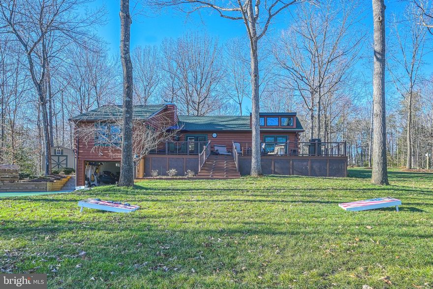 Here's your second chance to own this gem!  Back on the market due to no fault of the seller and priced at the latest appraised value.  Welcome to Cozy Bear Cabin, a sanctuary for the soul set upon the beautiful shores of Lake Anna, Virginia.  This waterfront retreat on the public side of the lake will enhance your well-being and lifestyle.  Entertaining will be a breeze at this peaceful escape from reality with a professional pickleball court, fire pit and hours of fun in the sun on the lake.  Take a stroll down to the beautifully designed two slip covered boathouse that was just completed in 2017 with one electric lift, double jet ski pad, large sun deck, covered entertainment area, tiki bar with roll up windows and a storage room for all your lake toys.  3 bedrooms, 3 full baths and hardwood flooring throughout.  The kitchen showcases new quartz counters and SS appliances with the centerpiece being a one-of-a-kind boat bar/island that is open to the dining area and the family room that features a corner stone gas fireplace.  The lakeside primary bedroom en suite has a walk-in closet, tile shower and its own door to the deck.  The upper level loft is the perfect place to cozy up with a book and perhaps take a nap. 1,000 Sqft of composite decking with LED lighting to relax and enjoy BBQ's on.  Whole house generator, 11-zone lake fed irrigation system, tankless water heater & water treatment system.  Paved concrete circular driveway, built-in 1 car garage, 24x30 carport and a shed with electric.  This home has many recent improvements and comes partially furnished!  Great lake location and just minutes from groceries and dining!  Grab your swimsuit, your family and friends for guaranteed memories and let your stress drift away.  **See list of full improvements and items that can be purchased separately in MLS documents** INVESTORS: Lake Anna was recently named the nation's TOP short term vacation "beach" rental location, and this property would make a fantastic investment asset.  Tall Pines Subdivision on Lake Anna DOES allow short term rentals and this property does have a newer rental history!  Come see for yourself and fall in love.