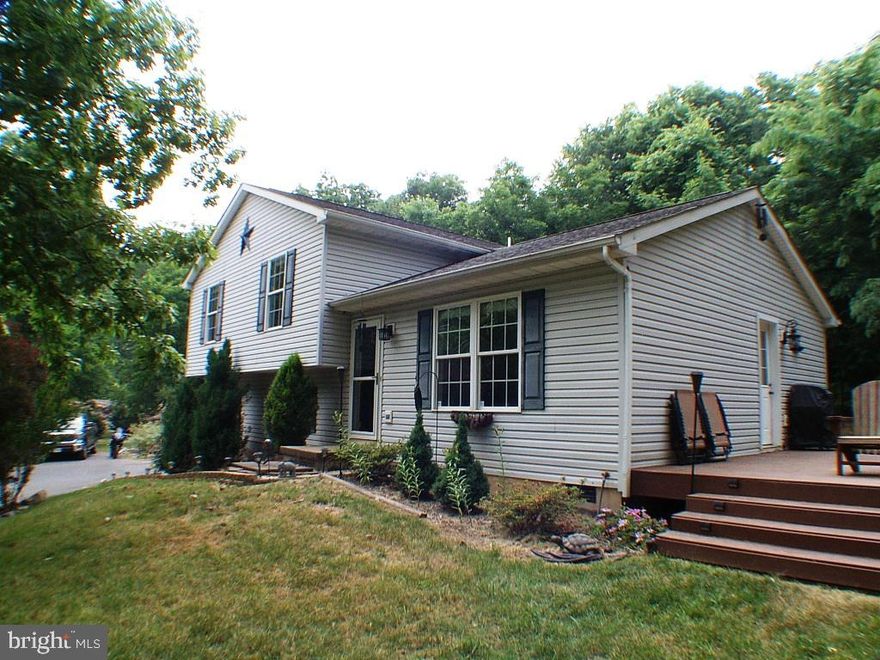 PRIVATE! PRIVATE! PRIVATE LOCATION! 1.28 acres with NO HOA. If your looking for paradise, you may have just found it. Drive up to the private cul-de-sac, & long private paved driveway to your new paradise. Many beautiful trees, shrubs & flowers. Oh, the flowers! Entertain anytime on your 24 X 16 Trex deck. 3 bedrooms and 2 /12 bathrooms. Big kitchen with a stainless steel refrigerator. Central heat & air-conditioning. Many birdhouses on the property, all you need is to come and enjoy nature. 1 car 24 X 12 detached garage with 30 amp power & 10 outlets. Invisible Fence bordering the complete property for your doggie. If interested, we have a list of the plantings, for instance, Many Roses, Clematis Hosta's and more. Water softener included.  DONT MISS THIS ONE, FOR GOODNESS SAKE! Backs to a 300 acre farm for added privacy. Not in the flood plain..