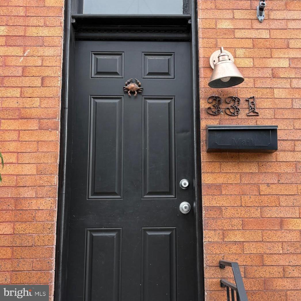 SELLERS HAVE SET A DEADLINE FOR OFFERS AT NOON MONDAY!! Welcome to 331 S Robinson. This charming row house, on a quiet street, is only only steps from Patterson Park. If you want updates plus character this is the house for you. From the striking facade to the period details you will fall in love. The tiled vestibule greets you as you enter into the open living area. The first floor has beautiful original pine floors, exposed brick walls, decorative ceiling tiles, crown molding, and decorative panelling. The kitchen is updated with a granite topped island and stainless appliances. The back door leads to a small patio and the convenient parking pad! There is an ample dining area and a huge front window that brings in the sunlight.
Upstairs, you will find two bedrooms plus a bonus room that could be used for an office, or large closet. The back bedroom opens to a private deck - shaded in the summer!
The basement is partially finished and has an exterior entrance so the space could be an extra bedroom, office or workout space. There is another full bath there. Recent system upgrades are a huge plus!
