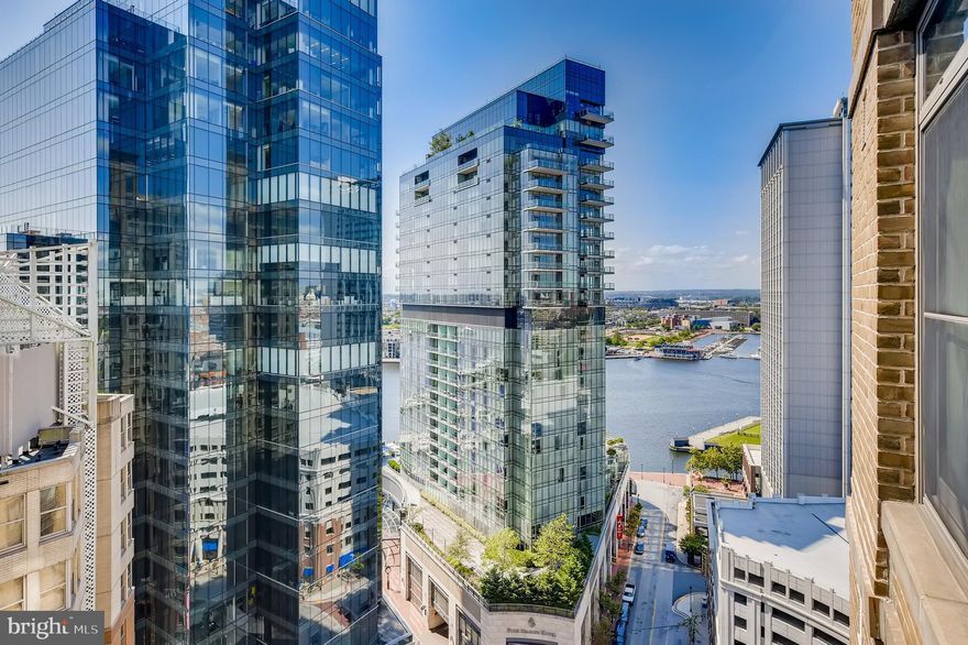 Spectacular two-bedroom, two-bath corner residence at The Vue in Harbor East offers breathtaking city and water views from every room. Designed for modern urban living, the home features an open floor plan with floor-to-ceiling windows, rich hardwood flooring, a gourmet kitchen with an expansive island, and a private balcony overlooking the sparkling waterfront and skyline. The spacious primary suite includes a walk-in closet and a spa-inspired ensuite bath with a double vanity, soaking tub, and walk-in shower. Two covered parking spaces and additional storage are included for ultimate convenience. Residents of The Vue enjoy front desk service, package acceptance, onsite management and maintenance, and access to a beautifully landscaped 8th-floor terrace—ideal for relaxing or walking your dog. Direct elevator access to the MAC Wellness Center and Harbor East Cinemas enhances the lifestyle, while top-tier dining, boutique shopping, and the waterfront promenade are just steps from your front door. With easy access to I-83, this is urban living at its finest—stylish, effortless, and right in the heart of it all.