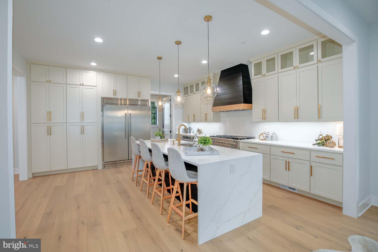 **MOVE IN READY NEW CONSTRUCTION!***. In the beloved Parkwood Neighborhood of Kensington ** This stunning, brand-new 5BR/4.5BA home in the heart of Kensington’s beloved Parkwood neighborhood offers three beautifully finished levels designed for modern living. The main floor welcomes you with beautiful wood floors, designer lighting, and oversized windows that fill the space with natural light. At the heart of the home is a spacious great room with a cozy gas fireplace, seamlessly connected to a show-stopping kitchen featuring Forno appliances—including an 8-burner gas range, quartz countertops, an oversized island, and abundant cabinetry. Just off the attached high ceiling garage, a practical mudroom offers the perfect drop zone for coats, bags, and everyday essentials. A formal dining room sets the stage for special gatherings, while French doors off the main living area lead to a private home office. A sleek, designer powder room rounds out the thoughtfully laid-out main level.
Upstairs, a generous loft landing offers the perfect spot for a reading nook or homework station. Two large bedrooms share a well-appointed Jack and Jill bath, while a third bedroom enjoys its own private ensuite. The extra-large primary suite is a true retreat, featuring multiple closets—including a custom walk-in—and a luxurious bath with double vanity, soaking tub, glass-enclosed shower, and private water closet. A convenient laundry room with a folding station, storage, and sink is also located on this level. The lower level is designed for maximum flexibility, featuring a spacious rec room with a wet bar, an additional bedroom with full bath and walk-in closet, a custom storage room, and a yoga/exercise space adorned with French doors.
All this and you're under a mile to many neighborhood favorites like Frankly Pizza, BabyCat Brewery, the Kensington Farmer's Market, Antique Row, and Safeway. Plus just minutes to the Kensington MARC station, the Wheaton Metro Station, Pike & Rose, Walter Reed, NIH, and so much more!