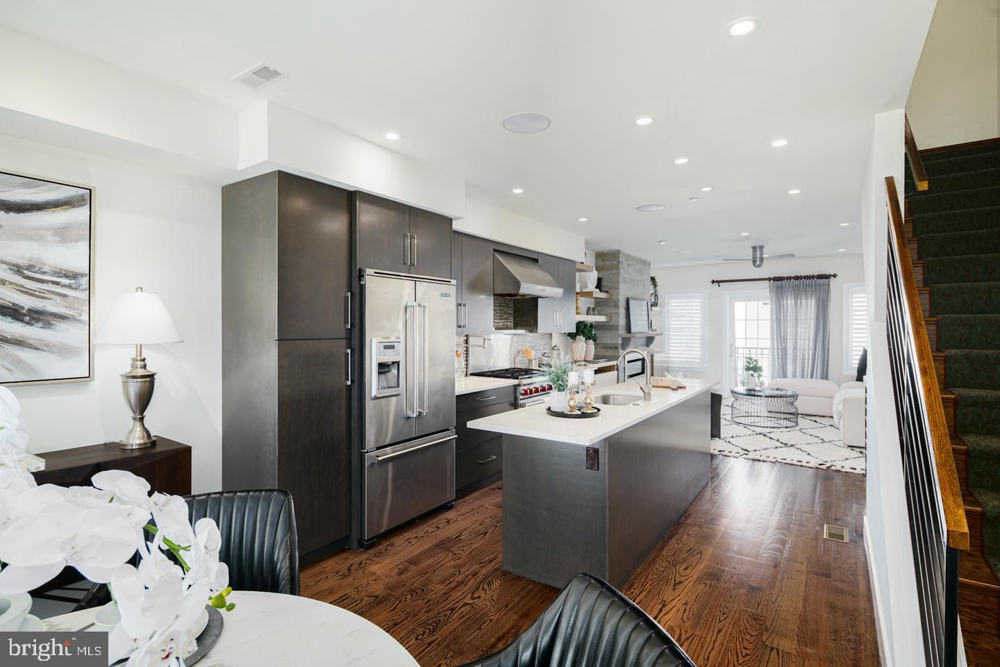 Steps away from Rittenhouse Square and nestled upon tree-lined Lombard Street sits this move-in ready three bedroom, three and a half bathroom residence. Complete with five light-filled levels featuring designer amenities, an oversized garage, and three years remaining on its property tax abatement, 1803 Lombard Street is one home you don’t want to miss. Did I mention it is also available FURNISHED?
After entering through the welcoming foyer, you’ll instantly fall in love with all that this townhome has to offer. Adorned with an elegant light fixture, the entryway leads to a powder room and the attached one-car garage. Ascend the staircase to your modern main level boasting an open-concept floor plan, rich wood floors, and oversized windows. The living room has custom built-ins, a private balcony, and a gas fireplace surrounded in brick. Adjacent, the chef’s kitchen showcases sleek wood cabinetry, upgraded quartz countertops, a large center island, high-end stainless steel appliances, including a Wolf range and Viking refrigerator, and ceramic tile backsplash. Adjacent to the kitchen, there is a formal dining area, ideal for entertaining with ease.
On the third level, two generously sized bedrooms with ample closet space share use of a designer-appointed hall bathroom with a dual vanity and tub shower. Nearby, there is a laundry room with a Whirlpool washer and dryer. Spanning across the top floor, a luxurious primary suite enjoys incredible custom-built closet space and a spa-like ensuite bath. This lavish bath has radiant heated flooring, floor-to-ceiling tilework, a soaking tub, a dual vanity, a glass enclosed stall shower, and a Toto toilet.
Pass by the wet bar and wine fridge to access the picturesque bi-level roof deck showcasing 360 degree city vistas. Offering an outdoor kitchen with a Solaire grill, lighting, and speaker system, this spot will truly serve as your personal city oasis. For added recreation space, the lower level leads to a full beverage bar, a climate-controlled wine room, a full bathroom, and storage - perfect for playroom, home office or media room!
The Lombard Estates is located in the desirable Greenfield Catchment in the Rittenhouse area. A nationally renowned green urban space, Rittenhouse Square is known for its host of tongue-wagging real estate, luxe shopping, and avenues chockablock with restaurants and bars that boast local character is just a few short blocks away