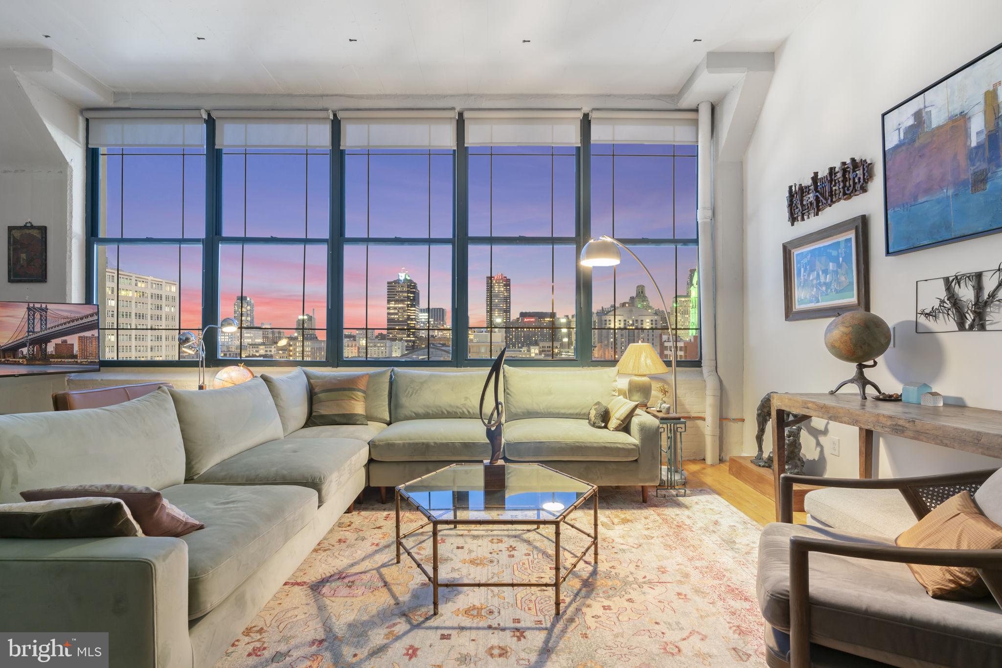 Sophisticated one-bedroom/one bathroom PENTHOUSE with unobstructed, dramatic southern views of the city skyline in the Heart of the Callowhill/Loft neighborhood.
Experience modern city living at the Old Shoe Factory Condominium at 314 N 12th Street in PH-1007. Be instantly impressed with its soaring ceilings, exposed brick, original pillars, expansive views from oversized windows, and hardwood floors.
Open-concept kitchen with high-end stainless-steel appliances includes an induction cooktop, a warming drawer, LG side-by-side refrigerator with dual ice maker, water and ice dispenser, wine rack, sleek cabinetry, a spacious island, and plenty of counter space. The seamless flow between the living, dining, and kitchen areas is perfect for flexible furnishings and entertainment. The extra-large living space allows for endless possibilities. Create versatile layouts, whether you want a cozy lounge, a separate dining area, a home office, or an entertainer's dream. The primary suite offers a true bedroom with plenty of light, a ceiling fan, a skylight, and plenty of storage. The bathroom features a large walk-in shower with dual shower heads, a double vanity, and access to the laundry/storage room. 1,049 square feet (+/-)
Located in the vibrant, industrial-chic pocket of center city Philadelphia. Just North of Chinatown and West of the Rail Park, adding green space to the neighborhood and steps from the Reading Terminal Market. A mix of converted factories, artist lofts, and new construction. For all you music lovers, The Met, Union Transfer, and the Underground Arts are within walking distance. The Philadelphia Ballet Theatre is one block away. Easy access to I-95, I-676, and Broad Street. Nearby Regional rail lines, Jefferson Station, and Suburban Station.
Whether you’re seeking a sleek city pied-à -terre or a statement home in one of Philadelphia’s most dynamic neighborhoods, this penthouse delivers it all. The seller rents a parking space one block away. Buyer may lease for $175/m. Pet-friendly.