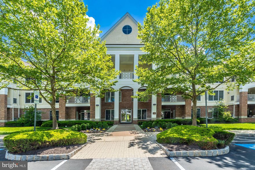 This a rare find on the market. . . A 2nd Floor, 1,874 sq.ft. corner unit with 2 Bedrooms, Sitting Room off Primary Bedroom and 2 Full Baths.  What differentiates this unit from most, is that it faces the front of the Building thus having magnificent views of the Pond, Fountain and Gazebo.  Because this is an end unit, there are also 2 covered Balcony’s. Upon opening the front door, one will immediately notice the depth of the Foyer which leads to the open and flowing floor plan enhanced by High Ceilings and Hardwood floors throughout.  The Island Kitchen with Granite countertops and Tiled Backsplash offers a new Gas Cook-Top, Stainless-steel appliances, Pantry and a significant amount of cabinet space.  The angled Island Is a great place to sit and verbally help the “Chef” cook while socializing.  The flow from the Kitchen to the Great Room is seamless.  There one will find the Fireplace and sliding glass doors leading to the covered Balcony facing the Pond, with stunning views at all times of the year.  Great Room is wired for sound.  Opening the double French Doors will lead you to the Sitting Room off the Primary Bedroom which can easily be used as an Office.  Primary Bedroom has a beautiful Walk-In Bay window and 2 separate Walk-In closets (each with organizers).  The Primary Bath offers clear glass oversized shower Stall with multiple heads offering medicinal shower enabling water massage of the body plus there is also a beautiful corner Soaking Tub.  The 2nd Bedroom has a Walk-In closet, sliding glass doors leading to covered Balcony and separate doorway leading directly to the Guest Bathroom.  Off the hallway between the bedrooms, one will find the closeted Laundry Area with Utility Tub.  Be sure to note that there is a Central Vacuum system, throughout the entire home. There is also easy access to the large storage unit and the private over-sized one car garage.   Reidents in this active 55 plus community can take advatage of the Clubhouse which offers, fitness center, billiard room, ping pong table and a library.  Plus use of the outdoor heated salt-water swimming Pool in the Summer and walking/jogging trails year round.   Besides this,  home is within walking distance to Valley Square Shopping Center & Wegmans.