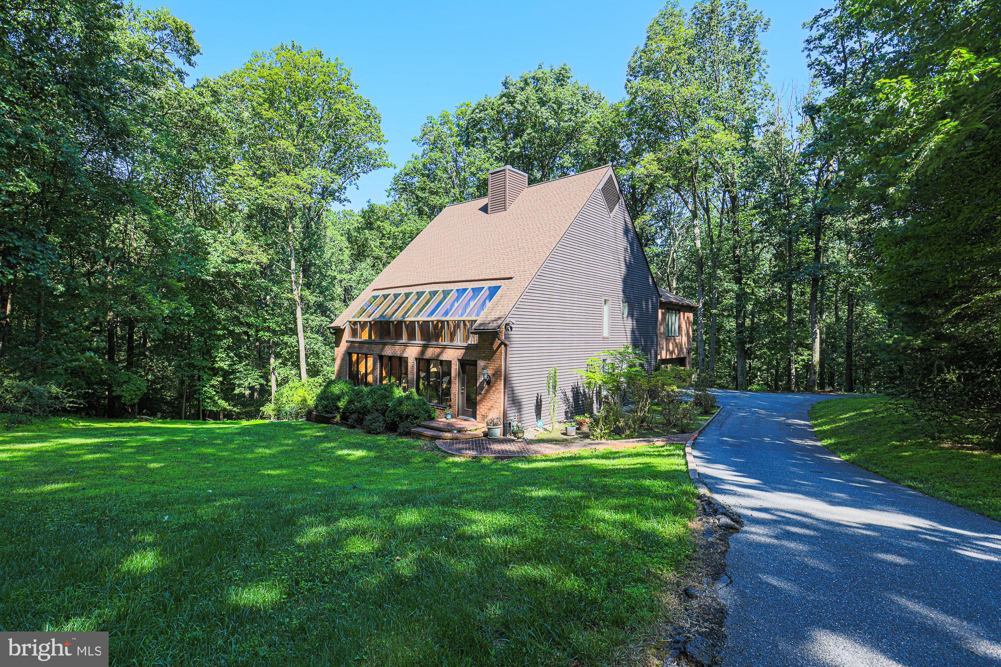Unique home in Sagamore Forest, nestled on over 2 acre lot. This Passive Solar Design Home offers an environmentally conscious, energy efficient infrastructure to heat and cool the home. Vaulted ceilings, recessed lighting, hardwood floors and skylights. Inviting family room with oversized windows and brick fireplace. This home has 2 master suites with plenty of closets and ensuite bathrooms. One has its own private balcony access to the Solarium.