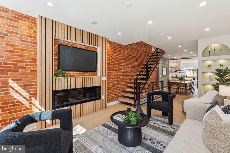 This beautifully renovated home, completed in 2025, showcases exceptional craftsmanship and meticulous attention to detail. With 3 bedrooms, 2.5 bathrooms, a finished basement, exposed brick wall and a private backyard, this property combines modern convenience with timeless style.

As you step inside, you'll be greeted by a bright and airy living room featuring an electric fireplace, perfect for cozy gatherings. The open-concept layout flows seamlessly into the dining area, followed by a convenient half bath and a sleek kitchen equipped with LG stainless steel appliances and marble countertops. The kitchen opens directly to the backyard, offering easy access to a grilling area and a charming shaded sitting space ideal for relaxing with family and friends.

The second floor features three spacious bedrooms and a beautifully appointed full bathroom featuring Porcelanosa tiles. The finished basement provides additional living space for entertaining, as well as a full bathroom and a dedicated laundry room with LG washer and dryer.

With white oak engineered hardwood floors throughout, a wide-plank staircase, Herdio speakers and a cozy fireplace, this home blends contemporary design with thoughtful details. PENDING 10 YEARS TAX ABATEMENT