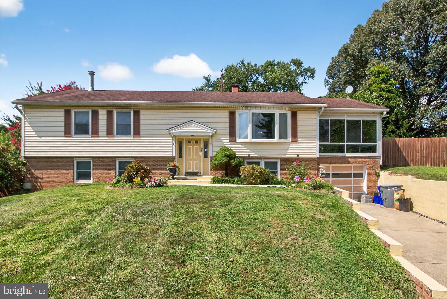 Very spacious split foyer with a resort-like yard. The main level includes spacious living room, updated kitchen, featuring granite countertops and stainless steel appliances which opens to the dining room. There is also a large sunroom. The main bedroom includes a newly renovated full bath (2024) with travertine tile shower and floor, along with new cabinet and fixtures. There are also two additional bedrooms and a hall bath. The lower level boasts a large recreation room with a gas stove and vintage inspired bar, greenhouse, additional room that can serve as a potential fourth bedroom, a utility-laundry room, and a one-car garage. The fabulous fenced rear yard includes a pool, a covered lounge area, a tiki bar, and a hot tub, evoking a tropical paradise atmosphere. Heating and A/C unit rebuilt ('25). A real beauty! (Note sq footage in tax record appears to not include lower level rec room and additional finished room - feel free to measure)