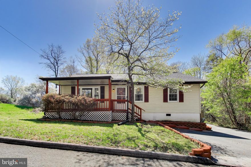 Beautifully updated rambler featuring 1,366 square feet of thoughtfully designed living space.  Recent upgrades include luxury vinyl plank flooring throughout and a renovated kitchen with quartz countertops, tile backsplash, stainless steel appliances, a 5-burner gas range, a built-in microwave, a center island, and a freestanding pantry cabinet.  Enjoy the light-filled sunroom off the kitchen with direct access to the deck and a fully fenced, private backyard backing to trees, complete with two storage sheds.  Originally a three-bedroom home, two bedrooms have been combined to create an oversized second bedroom, but can easily be converted back if desired. Additional highlights include a dedicated laundry room with built-in shelving and an updated full bathroom featuring ceramic tile flooring, a new tub, and tiled shower walls.  
The primary bedroom includes a supplemental baseboard heating unit for added comfort during colder months.  Relax on the large covered front porch, perfectly positioned on a quiet, no-through street ideal for peaceful living.  Major updates include a new roof and septic system (2023).