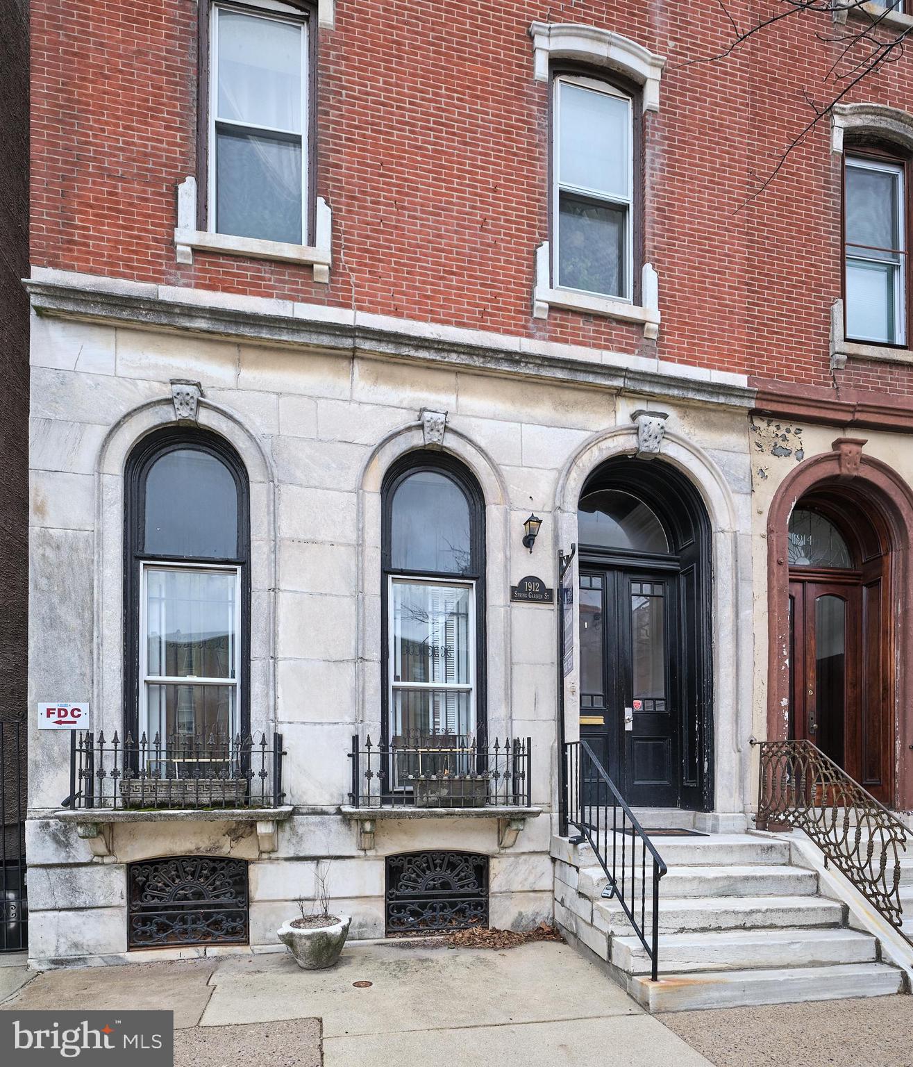 A 'MUST See' condo for admirers of distinctive character, original details, and abundant natural light! Set in a stunning historic Victorian Art Museum mansion, this unit is a blend of modern comforts with the timeless charm of its original craftsmanship. Inside, you'll be greeted by impressive high ceilings, exquisite ornate moldings, classic wainscoting, a grand decorative fireplace with a cast iron inset, tile surround, carved wood mantle, and a full-length pier mirror that reaches all the way to the ceiling. The newer windows are framed with the original intricate molding and feature wood shutters, creating a bright and welcoming bay window in the living room.
The entryway features a custom shelving closet and a convenient half bath - fantastic added feature! Beyond the living room, you'll find a spacious kitchen featuring granite countertops and stainless steel appliances and conveniently located in-unit washer and dryer in the hallway,
The en-suite bedroom is flooded by natural light from eight windows, offering bright views from every angle. It also features a roomy bathroom and a custom closet. Step outside to a spacious (20' x 12') private outdoor terrace, with access to the shared breezeway. Extra closet space and a basement storage unit complete this unique condo.
Living in the Art Museum/Fairmount neighborhood gives you easy access to its acclaimed restaurants, shopping, cultural landmarks, and plentiful green spaces. You’ll be within walking distance of Wawa, Target, Whole Foods, the Philadelphia Museum of Art, Pizzeria Vetri, Starbucks, Sabrina’s Cafe, and much more!