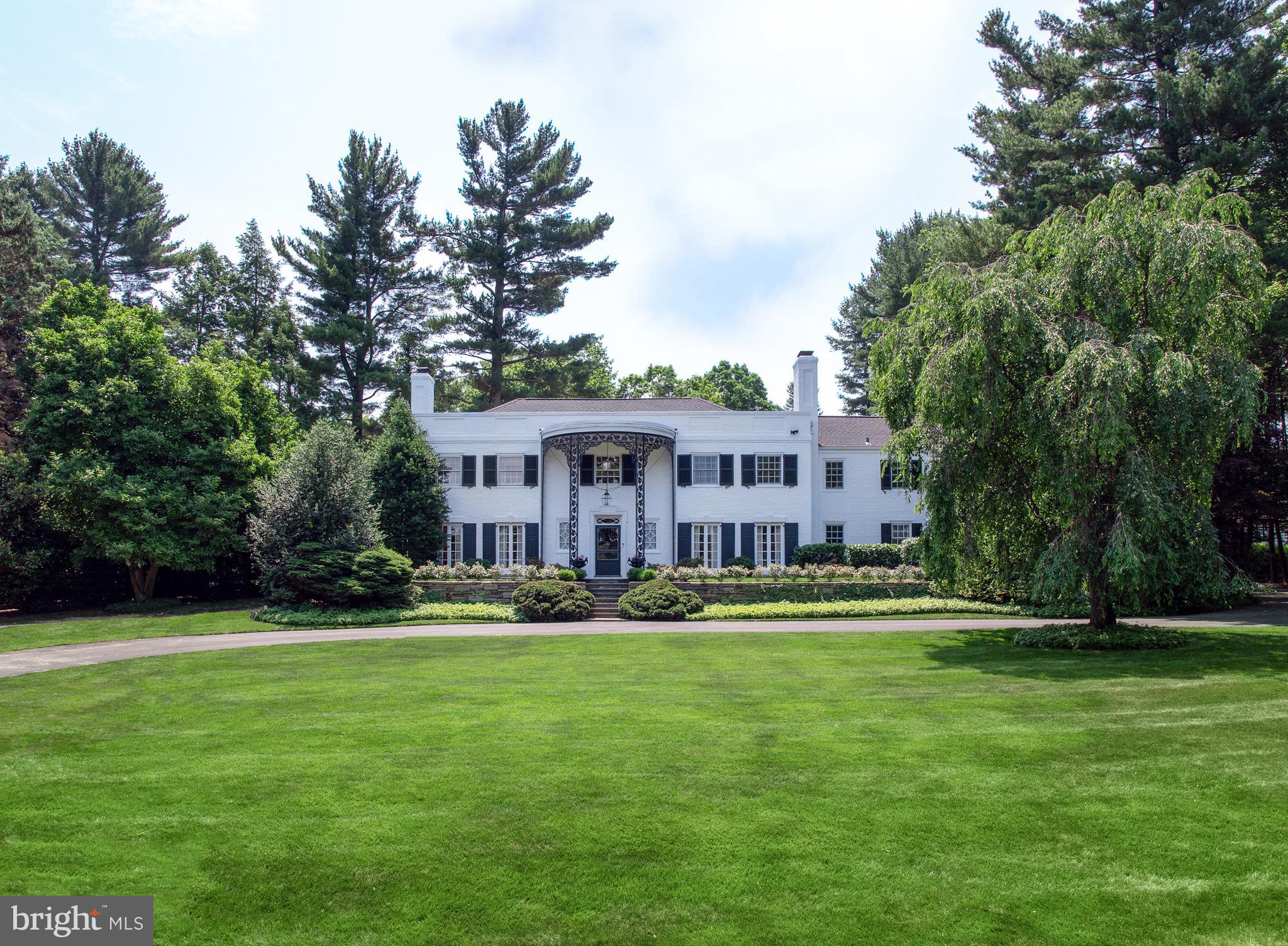 Grand, gracious 5 bedroom 4.5 bath home in a lushly landscaped private setting, on one of Northside Bryn Mawr s most desirable streets! The sprawling 1.89 acreage extends from Muirfield to Waverly Road and affords an expansive flat rear yard for outdoor parties & recreation, stunning specimen trees & plantings, a lovely secret garden with utility shed, tree house, and unique tree sculptures by renowned local artist Marty Long. As alluring is the divine heated in-ground pool and spa enveloped by greenery where you can lounge, relax & swim. Beautiful flagstone terraces showcase views of the park-like grounds and provide a perfect backdrop for hanging out with family or entertaining guests. An elegant circular front drive welcomes you upon arrival and deer fencing surrounds the property. The house has been thoughtfully updated and meticulously maintained over the years, with recent improvements including a fully renovated pool & replaced pool heater; newer roof completed in late 2018 by Russel Roofing; new heaters, new AC unit & all new thermostats (2020); a new septic system (2020); and updated irrigation system (2019). Beyond a unique towering covered main entrance is a double-height center hall with a striking staircase rising to an open landing. The gorgeous wood floors & millwork spill into the generous public rooms offering a flowing layout for the host and comfortable living for any size family. A large living room centered by a fireplace is brightened by oversized windows & 2 sets of tall French doors to the outdoor oasis. The spacious formal dining room, also with glass-paneled French door, can fit a huge crowd for sit-down meals, holiday gatherings & special occasions. A charming library with built-in bookcases & wet bar is a great spot for reading or sipping cocktails by the fire. Chef and family will love spending time in the expanded kitchen with skylights, wood cabinetry, center island with stovetop, built-in fridge & freezer, and stainless steel appliances. Open from here is a sun-bathed breakfast area for morning coffee & snacks, and wonderful family room with a fireplace, built-ins & glass doors to the patio and yard. The comforts continue with surround sound, a sky-lit sunroom, and mudroom with laundry off the 3-car garage. The upper level offers a large master suite with a huge sitting area featuring high, vaulted ceilings & his/her baths & closets. 4 additional bedrooms & 2 full baths, an alarmed cedar closet with safe, plus tons of closet storage round out the 2nd floor. Best of all, besides what the spectacular home has to offer is the location close to conveniences, from shopping & dining to top schools, the train & major routes.