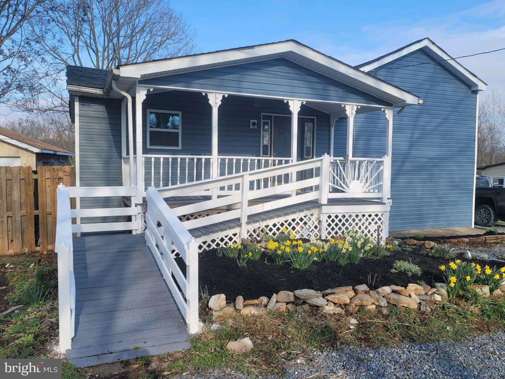 Renovated from top to bottom including mechanical systems, this home has the character and modern amenities you'll love just minutes from Rt. 340! Upon entering from the inviting front porch, you'll find an open concept kitchen with all new cabinets, counters, appliances, and tile backsplash, plus plenty of room to add your island of choice or a small dinette. A main floor bedroom is conveniently located across from a spacious bathroom with double vanity, tile floors and shower, and all new fixtures. The back room has an entry to the back deck and could be used as an office, dining space, or hobby room. Upstairs are two additional bedrooms, one larger with a vaulted ceiling and 2 attractive ceiling fans. The lower level has a good sized family room with access to the side yard. From there, you can access the unfinished basement with laundry facilities, a generous work bench, and room for storage. Outside is a detached garage for additional storage space. The convenient location of this move-in-ready home makes it even more desirable. Come check it out today!