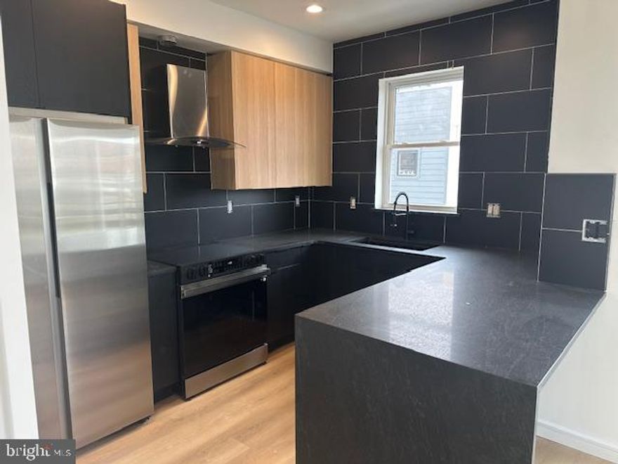 Luxury Corner Apartment in the Heart of Fishtown with Stunning City Views

Experience upscale city living in this extra-wide, designer 2-bedroom, 2-bathroom apartment, thoughtfully designed with modern elegance and premium finishes, located in the vibrant Fishtown neighborhood of Philadelphia.

Step into a bright and airy open-concept living space featuring custom-trimmed accent walls, overhead lighting throughout, and a stylish kitchen equipped with two-tone designer cabinets, matte black quartz countertops, a waterfall island, and premium Samsung appliances, including a built-in microwave. Pendant lights add a sophisticated touch to the kitchen, while the pantry provides extra storage for all your culinary needs.

Enjoy seamless indoor-outdoor living with a balcony off the kitchen, perfect for your morning coffee. The spacious primary suite boasts a double vanity, radiant heated bathroom floors, and a Bluetooth speaker in the shower for a spa-like experience. Two walk-in closets with custom organizers provide ample storage.

Additional features include central air and heat, full-size laundry, and a dedicated parking space. Security and convenience are top priorities, with exterior surveillance ensuring peace of mind.

Relax and entertain on the expansive rooftop deck, offering unobstructed skyline views—an ideal setting for enjoying city sunsets.

Located in Fishtown, one of Philadelphia’s trendiest and most sought-after neighborhoods, you'll be steps away from top-rated restaurants, boutique shops, lively music venues, and cozy cafés. Enjoy easy access to public transportation, major highways, and the scenic Delaware River waterfront, making this the perfect place to call home.

Don’t miss this opportunity to live in one of Philly’s hottest neighborhoods—schedule your tour today!