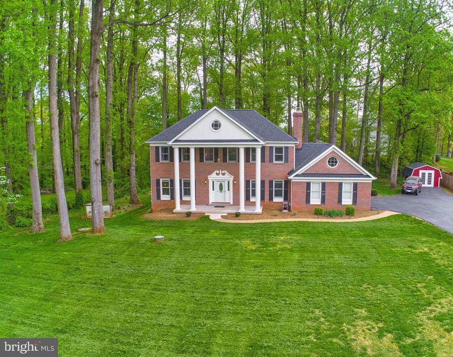 Gorgeous 4BR, 3.5BA Updated Colonial with Stately Brick Front & Majestic Columned Entry on Private 1+ Acre Wooded Lot with Picturesque Views in Warrenton's Sought-After Poplar Grove! Open, Airy Floor Plan! Inviting Foyer with Gleaming HDWDs & Exquisite Mouldings Opens to Formal Living & Dining Rooms Boasting Custom Mouldings!  Newly Renovated Kitchen with Granite, Updated Cabinets, Newer Stainless Appliances & Tile Flooring Opens to Breakfast Room with Sunlit Bay Window! Spacious Family Room with Custom B/I Bookshelves, Cozy Fireplace, Newer Neutral Carpet & Sliding Glass Door to Private Screened Porch.  Expansive Master Bedroom Retreat with Spacious Walk-In Closet, Private Master Bath with Double Vanities, & Sitting Room/4th Bedroom. Convenient Upper Level Laundry Location!  Newly Remolded Finished Lower Level with Sunlit Walk-Out Stairs Elevation, Upgraded Tile Flooring, Large Great/Rec Room with Wet Bar Rough-In, Den, Office/Media Room/5th BR w/Walk-In Closet with Additional Washer/Dryer Hook-Up, Updated Full BA, & Ample Storage!  Backyard Oasis Features Private Screened Porch & Multi-Level Deck Overlooking Enchanted Forest Backyard! Newly Renovated Shed with Electric! TONS OF UPDATES--Fresh Neutral Paint, Newer Carpet in Family Room & Upper Level, Lighting/Ceiling Fans, Most Baths Updated, Newer Roof, Hurricane Heavy Garage Door w/Opener, H/W Heater, Septic Distribution Box, Newly Reconstructed Front Porch Concrete, & Much, Much More!  No HOA! Great Location!  Minutes to Historic Downtown Warrenton, Medical Facilities, Schools, Shopping, Commuter Arteries & More!