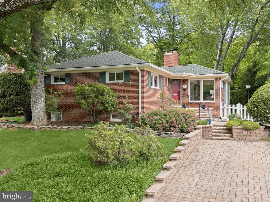 Welcome to this charming brick home in the heart of sought-after Garrett Park Estates! From the moment you arrive, you'll fall in love with the beautiful landscaping, classic white picket fence, and convenient paver driveway. Step inside to find gleaming hardwood floors that flow throughout the main level, creating a warm and cohesive living space. The formal living room is flooded with natural light from oversized picture windows and anchored by a cozy gas fireplace with a stone mantel. Just off the living area, the sunlit dining room leads to the kitchen, perfect for both everyday living and entertaining. French doors lead to the heart of the home: a stunning finished sunroom with vaulted ceilings, skylights, and walls of windows offering serene views of the lush backyard. Step out onto the stone patio to enjoy effortless indoor-outdoor living in your fully fenced, flat yard. The newly refreshed kitchen features brand-new stainless steel appliances, a gas stove, counter seating, and a garden window over the sink with backyard views. A second entrance provides convenient access to the outdoor space. On the main level, you'll find three generously sized, freshly painted bedrooms, each with large closets and built-in organizers. A skylit hall bathroom with a soaking tub, along with linen and coat closets, completes this level.

The fully finished and completely renovated lower level offers exceptional additional living space, complete with new LVP flooring, recessed lighting, and fresh paint. Enjoy a large recreation room perfect for a game table, media setup, or both, highlighted by a cozy second fireplace with an exposed brick surround. An additional spacious bedroom with natural light and a newly built stylish full bath featuring a tiled walk-in shower make this level ideal for guests. A dedicated laundry room with a utility sink and a large storage area add to the home's practicality.

Outside, unwind on the peaceful stone patio, surrounded by mature landscaping and beautiful trees that provide shade and privacy. All of this is located just one mile from Pike & Rose, with its vibrant dining, shopping, and entertainment options, as well as nearby parks and top-rated public and private schools. Don’t miss your chance to own this spacious, updated home on a fantastic lot in the highly coveted Walter Johnson High School district!