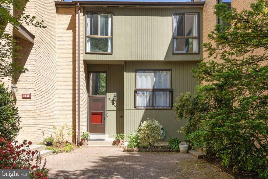 Welcome to this beautifully maintained townhouse in the wooded community of Chesterfield Mews!   The contemporary design with large windows fills the space with natural light, creating a bright and airy feel. The kitchen has been tastefully remodeled with white cabinetry, quartz countertops, stainless steel appliances, and an abundance of storage. The open layout is ideal for both cooking and entertaining. Step out onto the cozy deck off the living room—perfect for relaxing. Upstairs, you'll find three generously sized bedrooms with ample closet space. The primary bedroom boasts large windows, a walk-in closet, and a private en-suite bathroom while the  two additional bedrooms share a hall bathroom. The lower level features a spacious family room complete with a wet bar, a large wood-burning fireplace, and access to a welcoming brick patio—ideal for indoor/outdoor entertaining or quiet evenings with friends and family. Additional highlights of this home include two assigned parking spaces located just steps from your front door.  Residents enjoy a range of amenities such as walking paths, a tot lot playground, and basketball and tennis courts, as well as direct access to the County Trail. The home is situated in a prime location with Woodson HS Pyramid —less than a mile from Trader Joe’s, the Mosaic District, and a variety of restaurants and grocery stores. Quick access to Inova Fairfax Hospital, Vienna Metro Station, I-66, and I-495.  Please note: the HOA fee of $120 per month is billed on a semi-annual basis. Park at parking space #69 or at circle on Guysborough Dr.