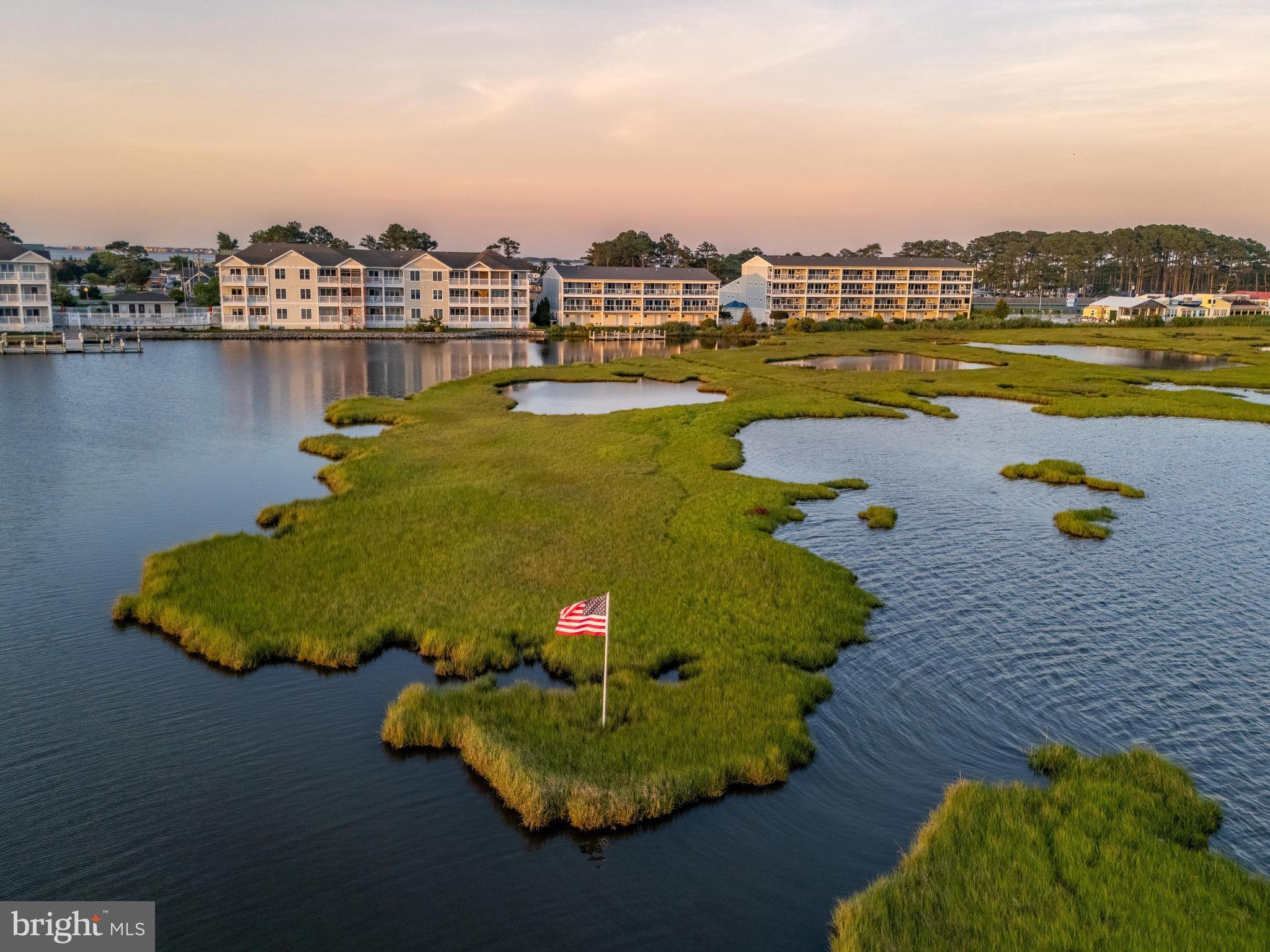 Welcome to Mallard Cove on the bay, a private community of 16 residences with direct Bayfront views.
This updated townhouse boasts 4 bedrooms, 4 bathrooms, 3 terraces and an open
concept main floor excellent for entertaining. The sizable kitchen includes 42” solid wood cabinetry, new granite counters, a tiled backsplash, stainless steel appliances and a beautiful custom island. The kitchen opens to a large dining and living room which provides beautiful unobstructed views of the Assawoman Bay. Completing the main living area is a bedroom, full bath, pantry and walk-in coat closet. Ascend the stairs to access three en-suite bedrooms, two of which have access to a third level terrace as well as a conveniently placed laundry room Recents updates include fresh paint, LVP flooring, custom window treatments, 2 zone HVAC system, and a new tankless water heater. Your private covered two garage provides able storage for all of your beach essentials. The Mallard Cove community includes a pool and day dock to launch your kayaks, go fishing or crabbing. The location is perfect, multiple restaurants within walking distance and Fenwick Island Beach is only a 2 mile Bike ride.