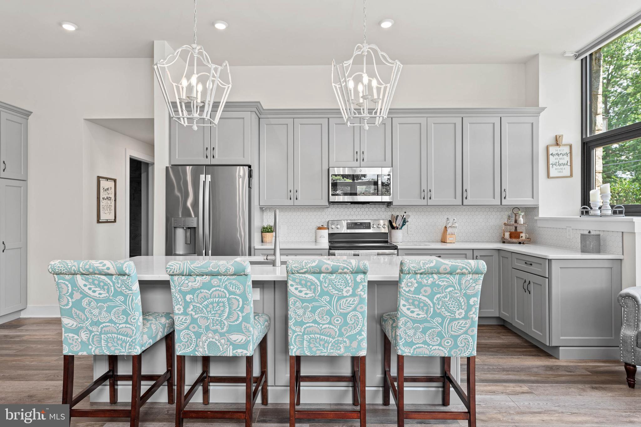 A luxury condo with low maintenance living all in one package! Unit A-107 is a custom-designed home featuring single-level living plus a private enclosed patio. As you enter the home, you are greeted with a beautiful oversized foyer with storage closets and access to an in-home office. The entryway leads to the open concept kitchen, dining, and living space. The building itself is an old school converted into luxury condos, and you will see touches of this throughout the home - exposed original brick, old repurposed doors, chalkboards, and more! Just off of the main living space is the primary suite, complete with a large walk-in closet and full bathroom. The second bedroom feels like another primary suite, equipped with it's own private full bathroom as well. This is one of only a few units with a private outdoor space, an enclosed patio off of the main living space and kitchen. Your own private sanctuary beneath the trees! In addition to the space provided in-home, this condo also comes with a dedicated 5x7 storage unit for your extra belongings. Outside of your home, the StoneSchool community has so much to offer! An outdoor community space with grills and a fire pit, walking trail, fitness center, D.I.Y. workshop room, community/party room, landscaped grounds, dog park, and covered parking. Unit A-107 comes with 2 parking spaces - one in a covered carport and another in the general parking lot. One of the parking spaces also comes upgraded with an electric charging station - a bonus feature that the owners added. This low-maintenance living community is within walking distance of local stores and restaurants, and is just a short drive to Route 422 and the Providence Town Center.