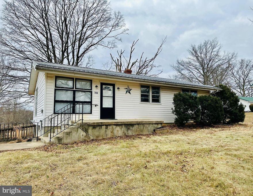 This well-kept, 3BR rancher is nestled on a lovely, unrestricted 1.18AC lot in South Berkeley County.  This home features gorgeous hardwood floors, 3 nice bedrooms and a spacious living room that opens to the kitchen.  Enjoy the great outdoors on this level lot that backs to open pastures and is within walking distance to fishing in Mill Creek.  Plenty of room to expand in the unfinished basement.  Main-level washer and dryer hookup optional in the 3rd bedroom or in the basement.  Countertops and refrigerator to be installed soon.  This home will not last long!