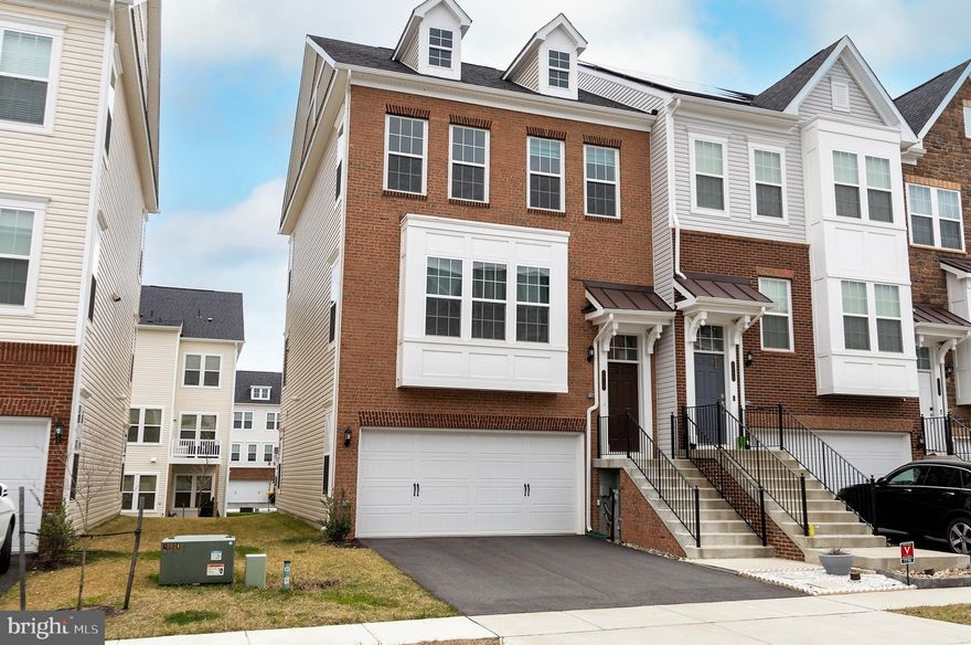 Welcome home to your stunning end unit townhome only 2 years young.  Why wait for a home to be built when you can be living in this beautiful, 3Br, 2 full bath, 2 half bath, sundrenched home next month.  This "Surrey" model Pulte Home boasts 3 levels with bump outs on all three levels and a spacious two car garage, with built in storage.  You'll love the welcoming, wide-entry foyer and enormous great room.  The wide open floor plan flows into a chef's dream, large gourmet kitchen with huge quartz top island, built-in wall oven/microwave, 42" upper cabinets, and large pantry.  Just off the kitchen is the bump out, perfect for an office, breakfast area, or gathering cafe that leads to the deck.  The main level has elegantly crafted engineered hard wood throughout and beautifully compliments the shaker style cabinets and tile backsplash, with stainless steel appliances.  The large second floor master bedroom has two walk-in closets and an impressive en suite bath, with dual vanities and fully tiled shower.   The other half of the 2nd floor has two more bedrooms and a full bath.  It also has a large hallway storage closet and conveniently located laundry room.  The bright and airy sun-filled basement is perfect for gatherings, with LVP floors, a wet bar with built-in mini fridge, a wine fridge, half bath, a landing zone for your coats and shoes, and sliders leading to the back yard.  The community has it all!  Enjoy the gorgeous community amenities to include a clubhouse, workout room, playgrounds, patios and picnic areas, two large pools and a kiddie pool.  Nearby, you'll find tons of shopping, access to major routes, minutes from the Marc train, and just a mile from Ft Meade.
