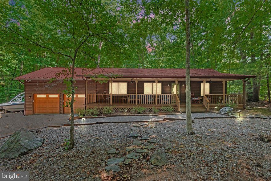 This well  enjoyed this Windwood Coves wooded lake retreat for over two decades. It is now time for a new owner to make their memories there. Enter the gated community and as you come down Lakewood Drive, you will see the lake while pulling into the driveway. There is plenty of parking for guests and all the lake toys! The log home with its stunning red roof sits on 1.03 acres of woods with partial clearing around the home. When you walk up to the huge covered front porch you envision manyhours will be spent there enjoying the peaceful ambiance. As you enter the well maintained home, the open floorplan, skylight, wood flooring, trim and molding gives you a warm inviting feel. The open kitchen, living room and dining room layout is perfect for gathering and entertaining.  The home has a split bedroom plan. The bedroom has a walk-in closet and an updated en suite with an amazing wood feature wall. The other two spacious bedrooms have plenty of windows and closet space.  The den is open to this area as well and overlooks the large back yard. It features the home's fireplace, which adds charm to this retreat. This room leads out onto the rear deck with an awning. There is a separate laundry area, two car attached garage, outside shower and a whole home fan are additional features of this home. (Some fixtures do not convey, please see exclusions)Head down to thecommon area at the end of the road and you will find your boat slip (#17),sandy beach and a lot of fun!! Golf carts permitted,short term rentals are allowed, high speed internet are just a few of theadvantages that Windwood Coves offers.  
Schedule your tour today!