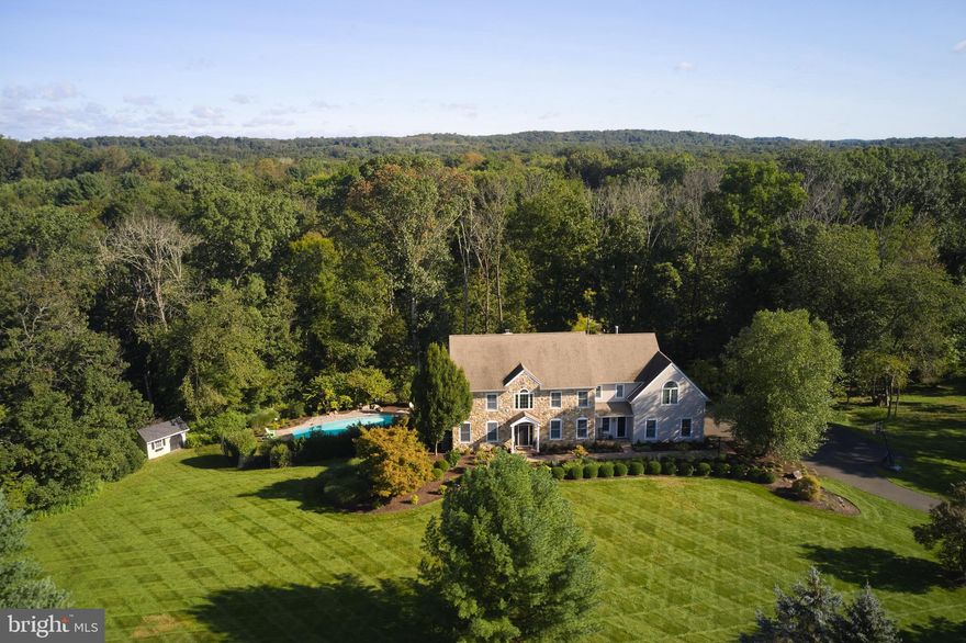Come see this beautifully maintained 4 bedroom 4 1/2 bath home in a desirable Doylestown community within the award-winning Central Bucks School District.  Situated on a private park-like 2.34-acre lot at the end of a cul de sac, just a few minutes from the heart of Historic downtown Doylestown.  Enter the soaring 2-story foyer with turned staircase, extensive trim work and hardwood floors. Nicely appointed Dining room and Formal Living room with shadow boxes and crown molding, finished with hardwood floors and neutral color palette, perfect for entertaining and family gatherings. The Formal Living room with built-ins and French doors leading to the bright and sunny private office.  Stroll down the hallway, you will appreciate fabulous gourmet kitchen w/ upgraded appliances, 6 burner Stove, subzero refrigerator, tile back-splash, granite counter tops, large breakfast bar, island, pantry, mudroom and butlers pantry including 2 refrigerator drawers and wine refrigerator.  The expansive family room with vaulted ceiling and stone fireplace complete this level.  Beautiful wide plank flooring throughout the 1st floor, 9 ft ceilings, custom painted, decorative millwork throughout much of the 1st floor.   Meander upstairs to the luxurious owner’s suite with vaulted ceiling, sitting room, enormous walk-in closet with closet organizer and gas fireplace. The spa-like master bath has separate vanities, a jetted tub, steam shower with speakers and seamless glass, linen closet and private water closet. The Princess suite has its own full bathroom. Two additional bedrooms are nicely sized. More living space can be found on the finished walk-out lower level. This area has many flexible uses such as a recreational room, game room, full bath, sliders to pool area and wine cellar that holds over a thousand bottles of wine.  The outside pool area is perfect for summer gatherings.  Very private back yard with oversized deck and steps leading to the patio, overlooking the woods.  Some of the many upgrades include 2 chandeliers on electric lift, shiplap on the cathedral ceilings, all bathrooms and kitchen updated, new (2021) HVAC and duct work on 2nd floor, new dishwasher, subzero refrigerator, microwave, all solid wood doors and much more.