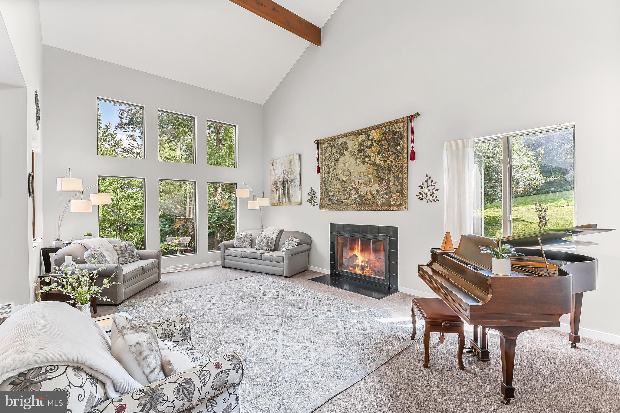Custom built contemporary home with beautiful exposed beams, two story ceiling and magnificent views of the woods and stream that run below the property. Located close to Rt. 52 and Rt 1 makes for an easy commute to Wilmington, Philadelphia, and Maryland and less than a 5 minute drive to AWARD WINNING DOWNTOWN KENNETT SQUARE. Neighborhood living but your have your own natural landscaping and screening which makes you feel like you found your private oasis. The home is perched on a hillside and has three floors of unique living space. Once inside you have a magnificent entry way which is completely open to the two story sunken living room complete with fireplace and a wall of windows that make you feel like you are living with nature. The dining room is completely open to the living room and has a glass door entry to the mid-level deck. The combination makes for the most amazing entertaining space which blends the indoor and outdoor spaces beautifully. The eat in kitchen is just beyond and is equipped with gas cooking, granite counter tops, and custom built solid wood cabinetry. The breakfast room has a beautiful greenhouse window and growing ledge which makes for the perfect place to grow your herbs or decorative plants. Just beyond the kitchen is the oversized laundry and mud room. Owners have added a full MAIN FLOOR MASTER BEDROOM with an ENSUITE Bathroom with a custom tiled shower. The master bedroom and bathroom are one flight up and encompass the entire half of the house and are open loft style to the areas below. The master bedroom is huge with ample room for a sitting area and it has sliding glass door access to its own private deck that overlooks the back yard. The master bathroom has a large soaking tub, a very long double sink vanity, and a separate shower. The walk in closet is large and there is a door in the back which leads to the attic storage area for even more space. One flight down from the entry level, are the other two bedrooms, the second full bathroom and a spacious family room complete with stone fireplace. The family room opens to another deck which is at grade and provides easy access to the gently sloping back yard. All decking has been converted to maintenance free deck and railing material. The underside of the main level deck has been waterproofed and the lower level deck is screened in with a ceiling and lighting above making this the perfect outdoor space to enjoy the amazing back yard. Three levels of decks, three levels of living space, a wonderful 1 acre open and partially wooded lot with stream & natural screening, all well maintained and conveniently located. Be sure to put this property on your tour and once you see it, you will want to call it home.