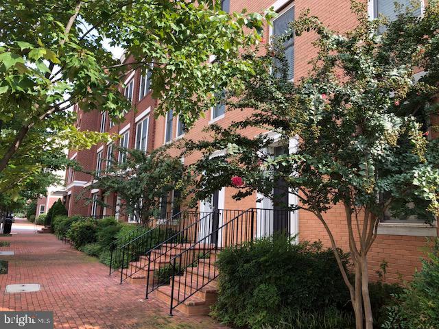 Spacious and beautifully upgraded 3BR/2.5BA townhome in highly sought-after Potomac Yard. This is the largest model available, offering 2,760 sq ft of open-concept living with 9-ft ceilings and wood floors throughout. The chef’s kitchen features a massive island, custom cabinetry, and professional-grade appliances, with a private balcony just off the kitchen. The expansive primary suite includes a luxury bath and oversized walk-in closet. Ideal for entertaining with multiple living and dining areas. Prime location—just minutes to Potomac Yard shopping, Metro, major commuter routes, Old Town, Del Ray, D.C., and Reagan National Airport.