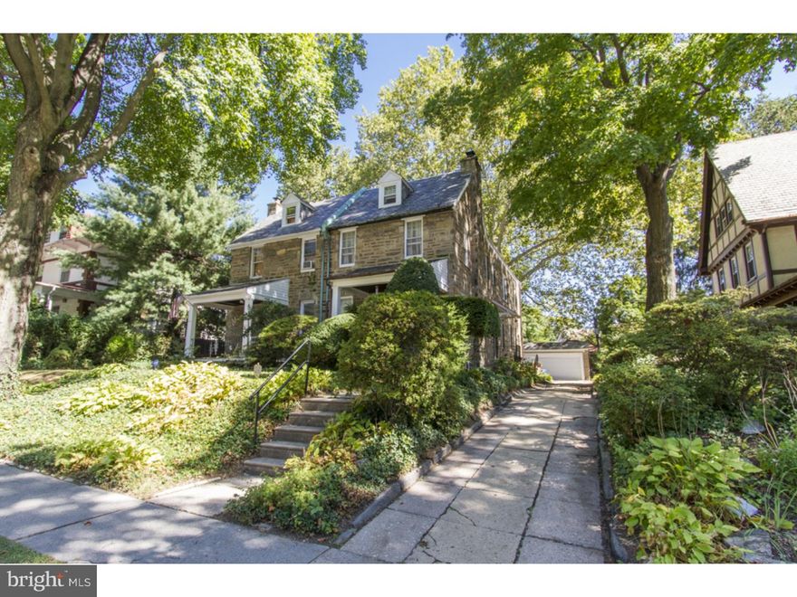 Classic Mt. Airy stone twin with an oversized detached garage and long driveway. Approximately 3000 sq ft including the basement, this well-maintained home has great traditional features and is ready to move right in. Large rooms, high ceilings, beautiful millwork and hardwood floors with decorative inlay. Enter through the center hall, which separates the large living room with stone fireplace from the spacious dining room with crown molding and millwork. The charming kitchen features a large farm sink and a clean, neutral color. Follow the stairs with beautiful wooden post banister to the second level where you will find three generously sized bedrooms with great closet space, and two full baths. The third level adds a bonus room and a third full bath. The bonus room could be used as a fourth bedroom, office or sitting room. Sit and relax outside on the quaint front porch or in the private back yard. The finished basement with wide oak plank floors and built-in shelves is great for a rec room, library, office or movie room. This street and property feature some of the most gorgeous mature trees in all of Mt. Airy. Less than a block from the Septa Regional Rail line at Stenton Train Station and an easy commute to Center City and major roads. An easy walk to all that Germantown Ave has to offer with its shops, restaurants, pubs, theater and public transportation. Close to Chestnut Hill and suburban Philadelphia. A great opportunity to own a very well-maintained house in move-in condition for under $300k. Set your appointment today!