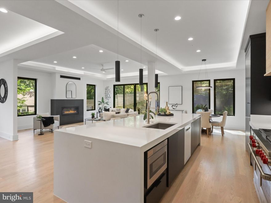 Step into refined luxury with this one-of-a-kind custom residence that seamlessly blends timeless Craftsman details with modern sophistication. Built in 2020 and designed for today’s lifestyle, the home spans over 5,400 square feet of thoughtfully curated living space.

The heart of the home is an entertainer’s dream kitchen, showcasing a dramatic waterfall island, Wolf range, Sub-Zero refrigerator, and an expansive pantry with breakfast nook. Flowing naturally into the dining and living areas, the space opens to a newly landscaped private backyard—ideal for gatherings and quiet evenings alike. A stylish lounge with wet bar and a versatile office/guest suite with full bath and balcony complete the main level.

An in-home elevator effortlessly connects all three levels, ensuring convenience and accessibility throughout the residence. Upstairs, four bedrooms each feature ensuite baths, highlighted by a serene owner’s retreat with its own sitting room, wet bar, spa-inspired Japanese-style bath, and a sunlit balcony with neighborhood views.

The lower level extends the lifestyle with a spacious recreation room, fitness area, and another wet bar for effortless entertaining.

Perfectly positioned near Washington, D.C., Georgetown, Tysons Corner, and Arlington’s best dining, parks, and trails—this residence offers the ultimate combination of luxury, function, and convenience.
Discover the pinnacle of Arlington living in a home designed to impress at every turn.